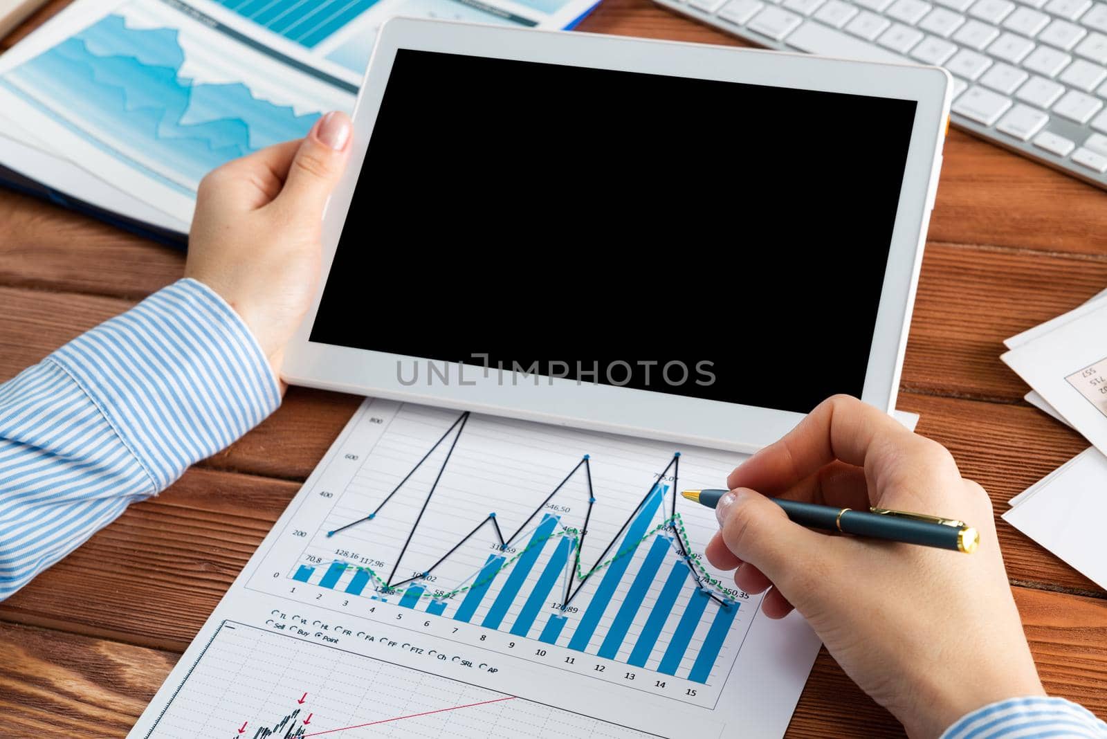 close-up, female hands with tablet. Business woman working at the table in the office