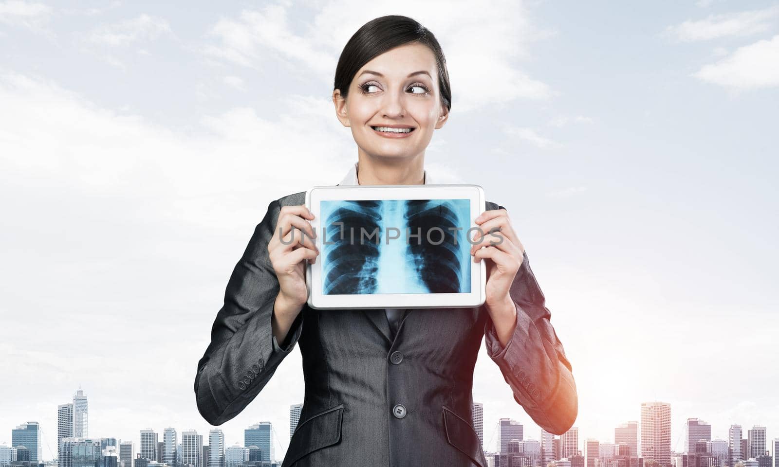 Businesswoman holding tablet computer with x-ray scan on screen. Smiling woman in business suit show tablet PC. Businessperson on cityscape background. Digital technology and medical diagnostics.