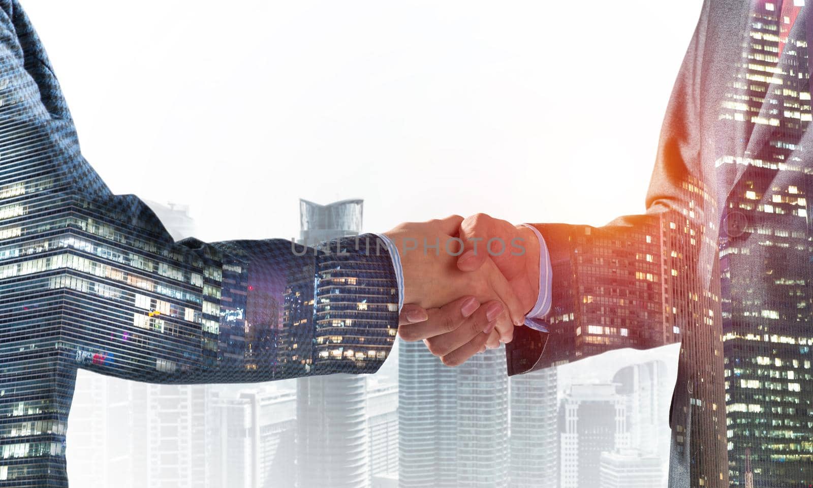 Close-up of the handshake of businessmen. Against the backdrop of the cityscape