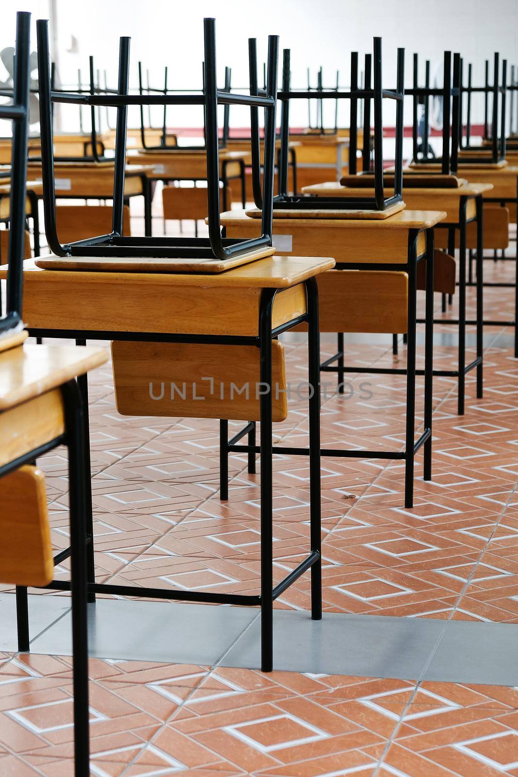 Desk and chairs in classroom by ponsulak