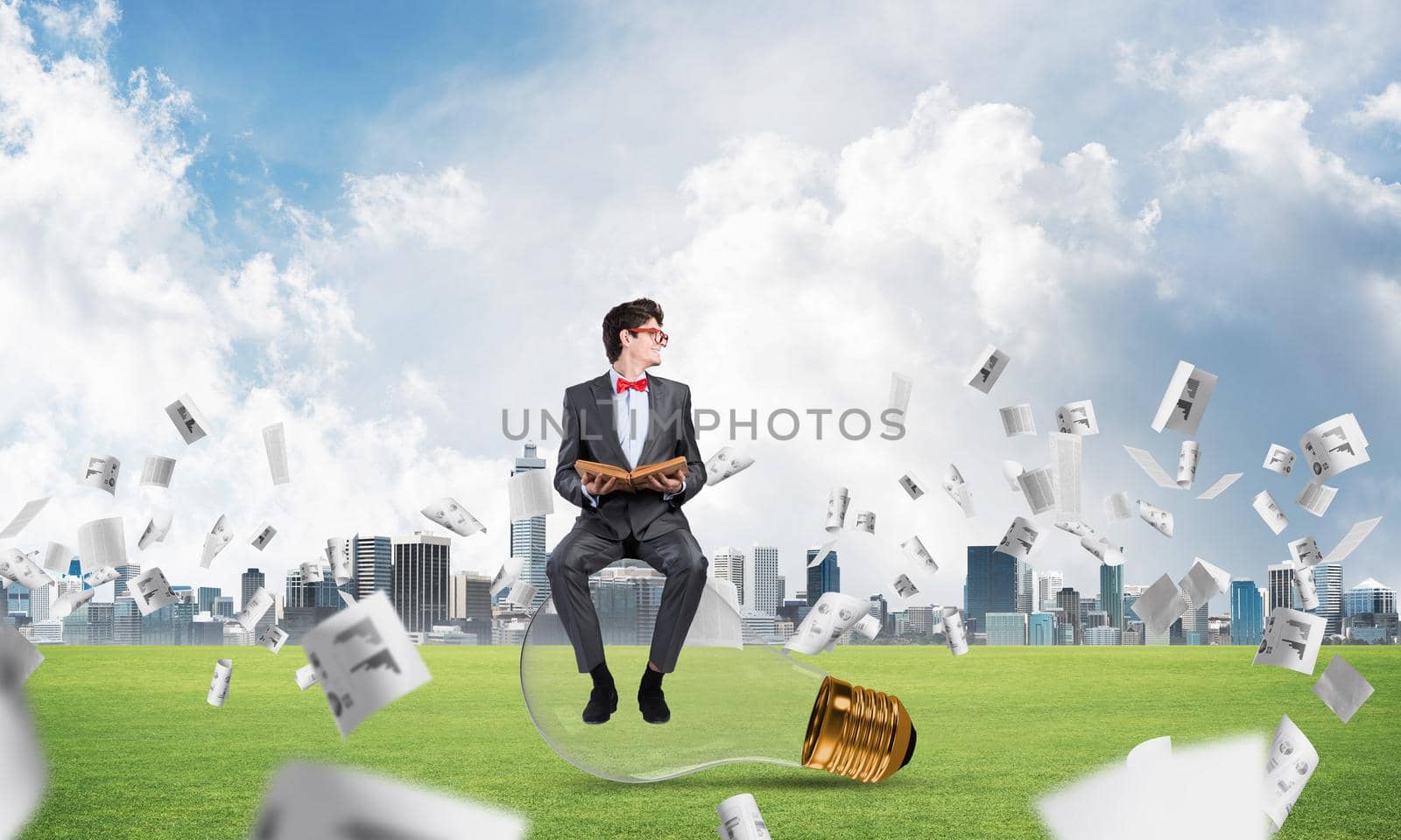 young businessman with a book. flying around papers in chaos