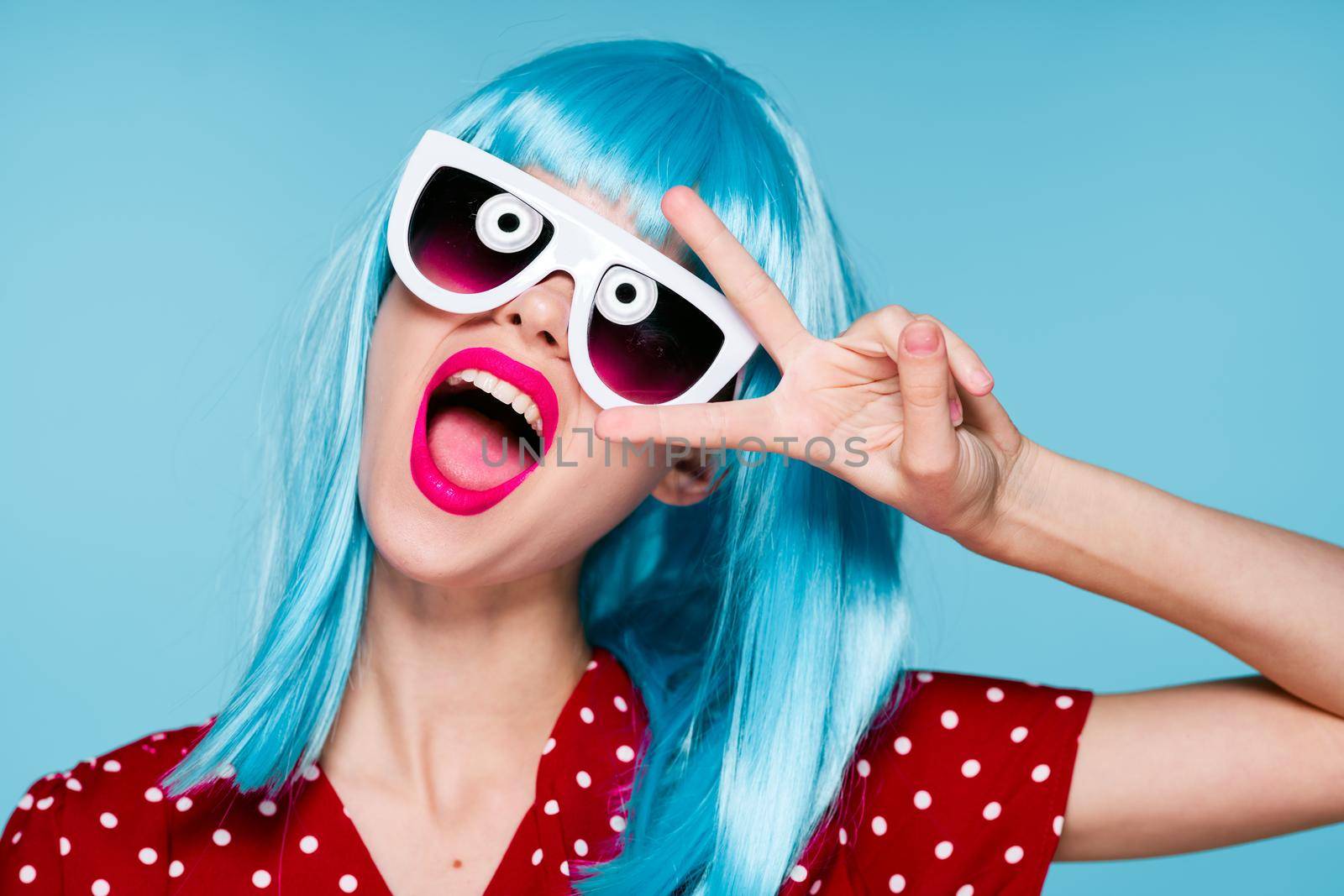 cheerful woman in blue wig sunglasses Glamor makeup. High quality photo