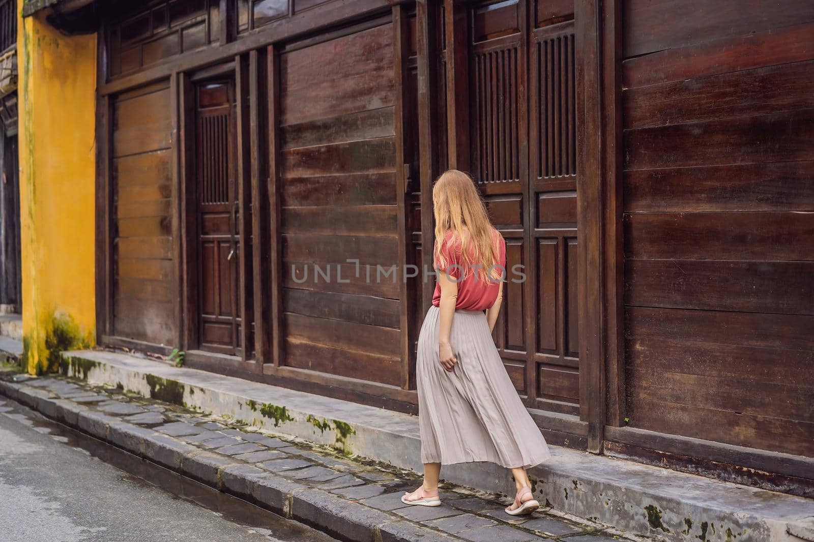 Woman tourist on background of Hoi An ancient town, Vietnam. Vietnam opens to tourists again after quarantine Coronovirus COVID 19.