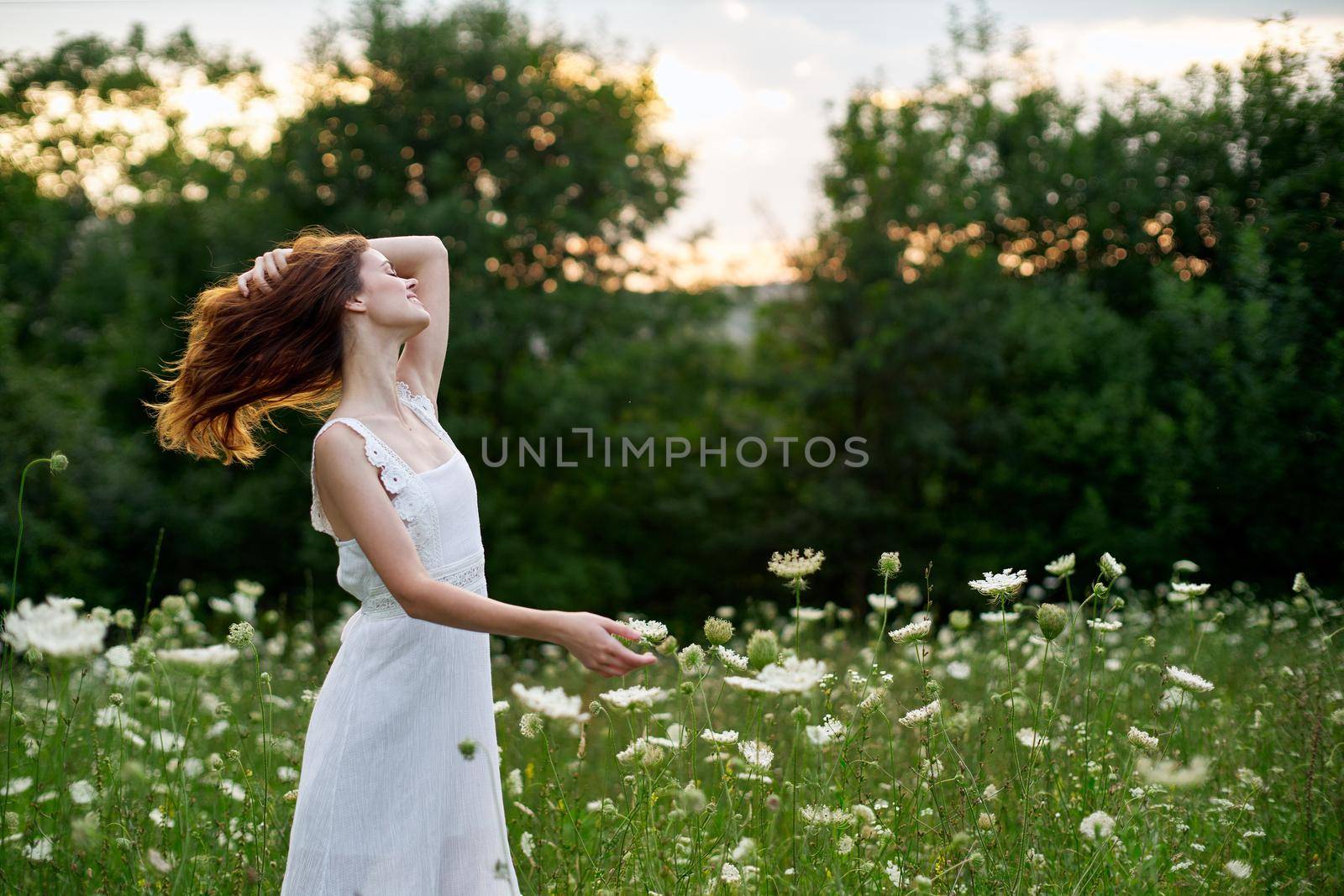 Woman in white dress in a field flowers sun nature freedom by Vichizh