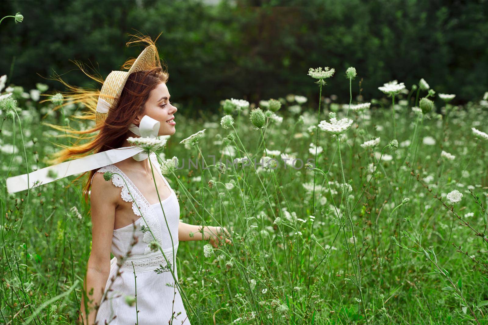 Woman in white dress and hat in a field with flowers lifestyle by Vichizh