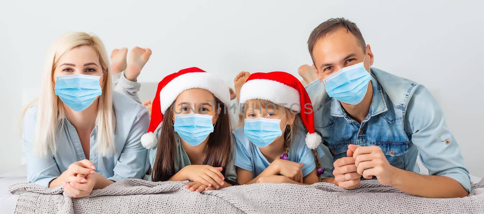 People with gifts wearing facemasks during coronavirus and flu outbreak on Christmas. Virus and illness protection, home quarantine. COVID-2019. by Andelov13