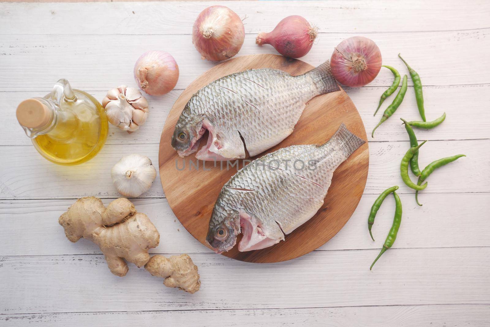 raw fresh sea fish on plate on table