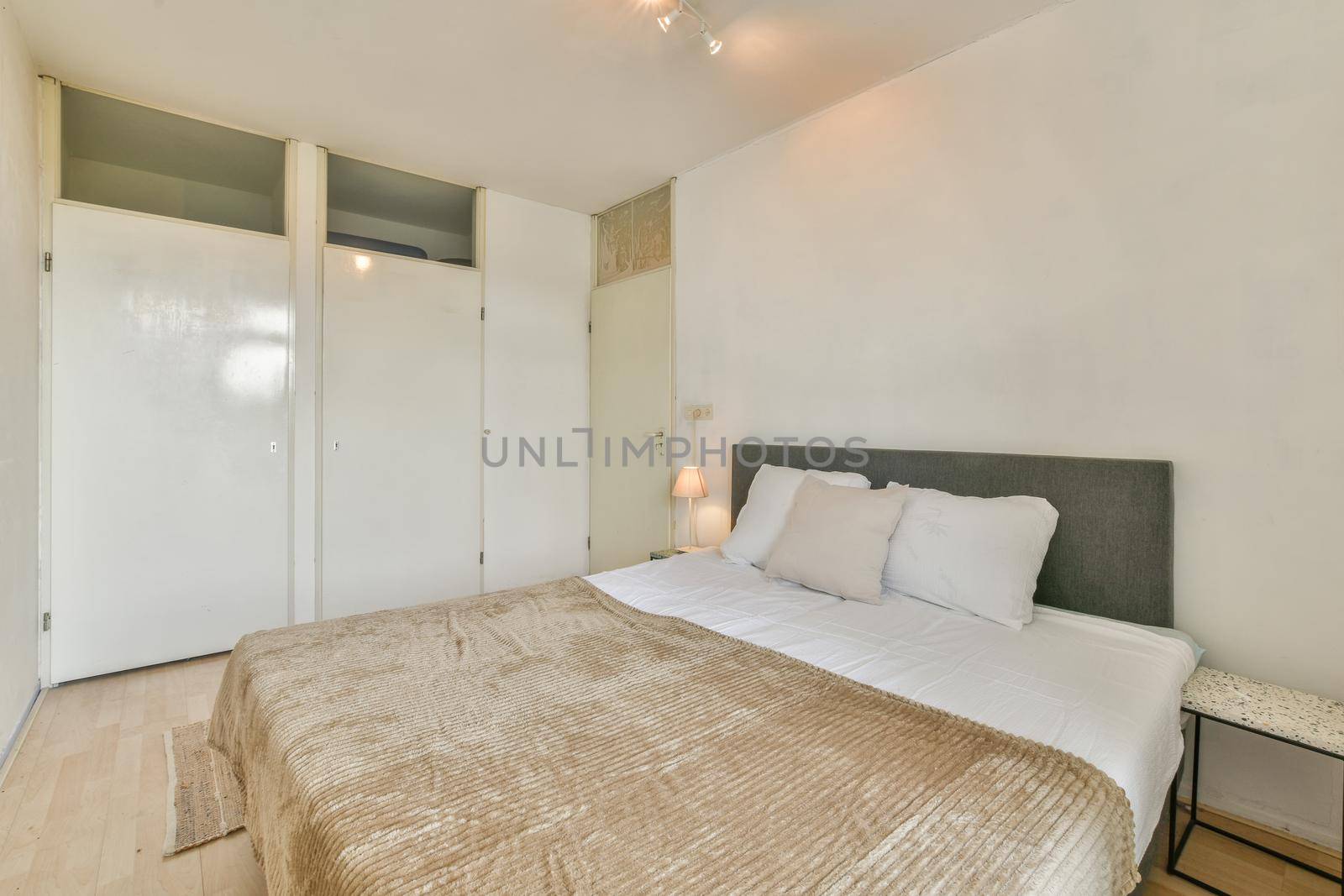 Large delightful bedroom with soft bed and parquet floor
