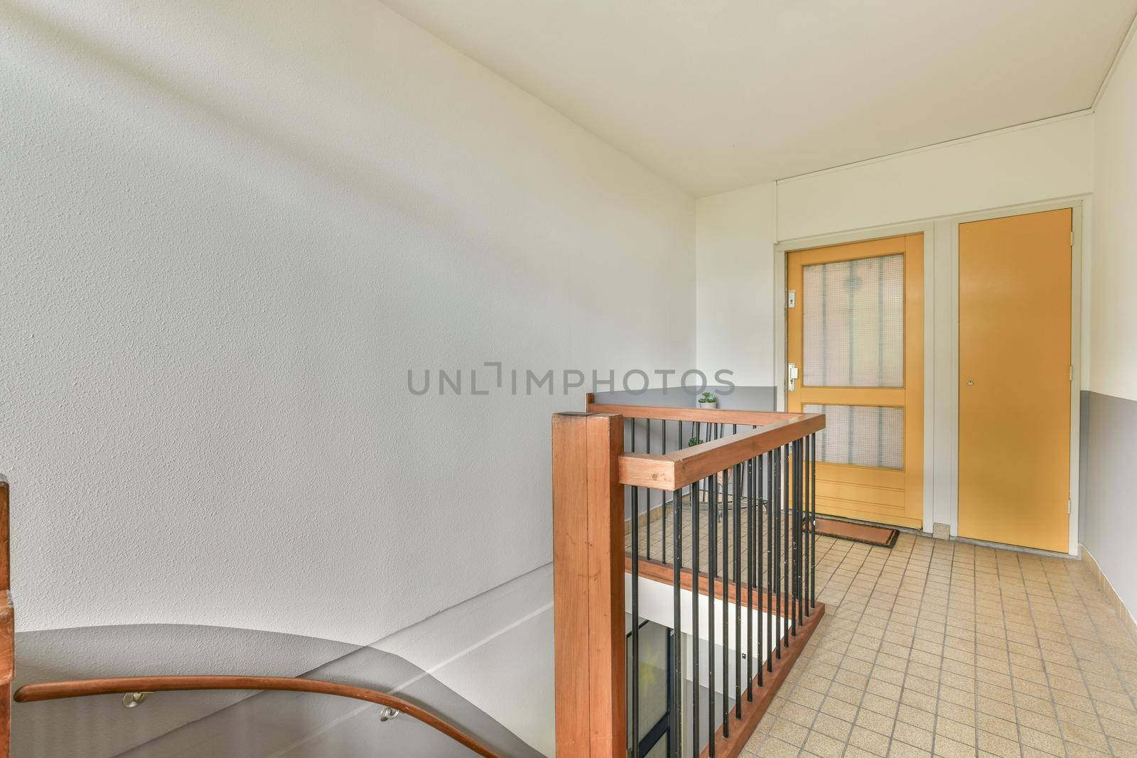 Corridor with wooden staircase and glass railings