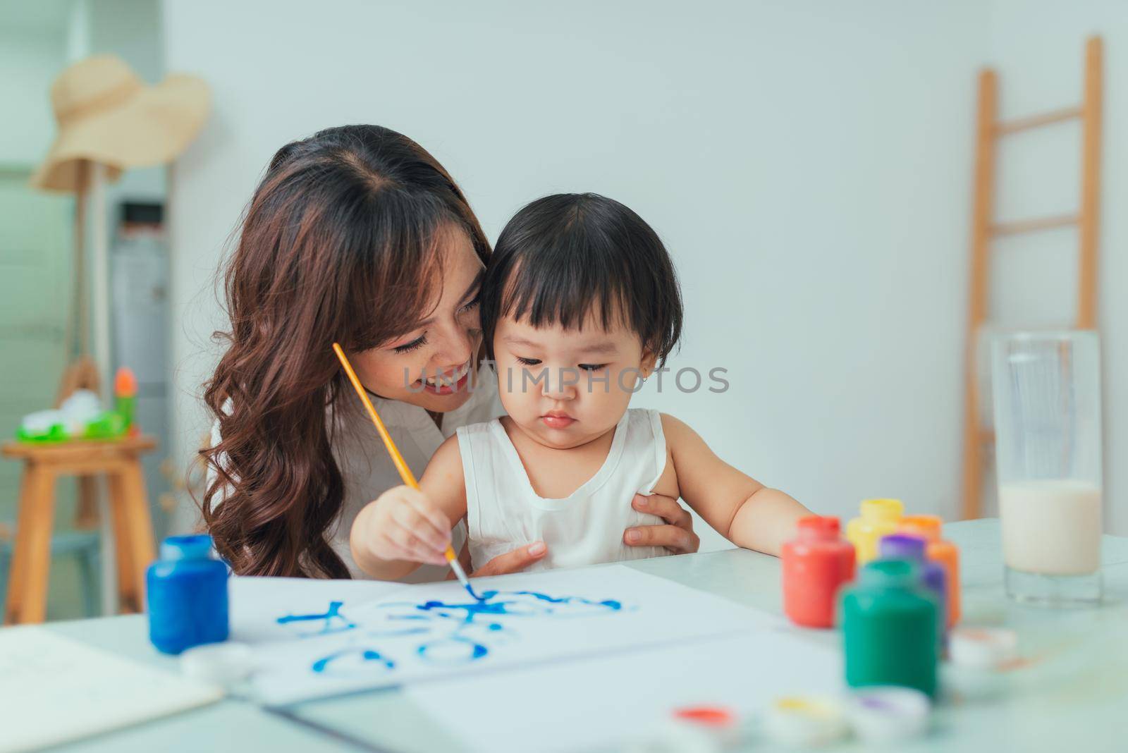 Asian mother working at home together with daughter