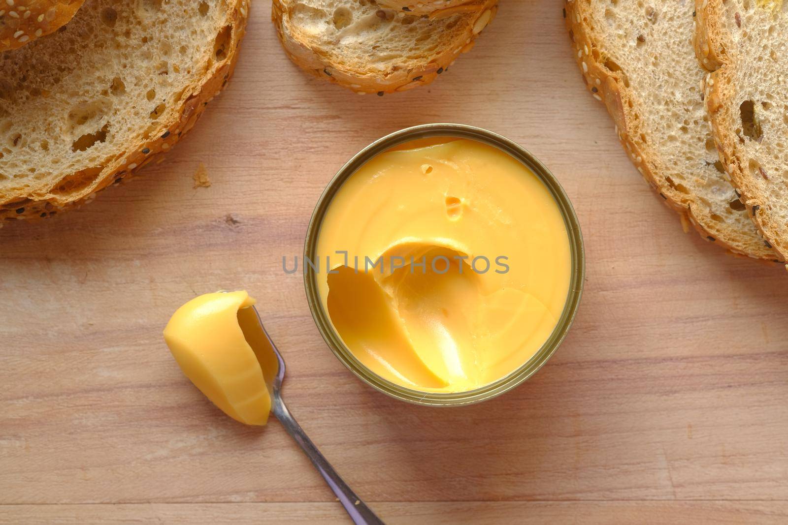 cheddar cheese in a tin container on table by towfiq007