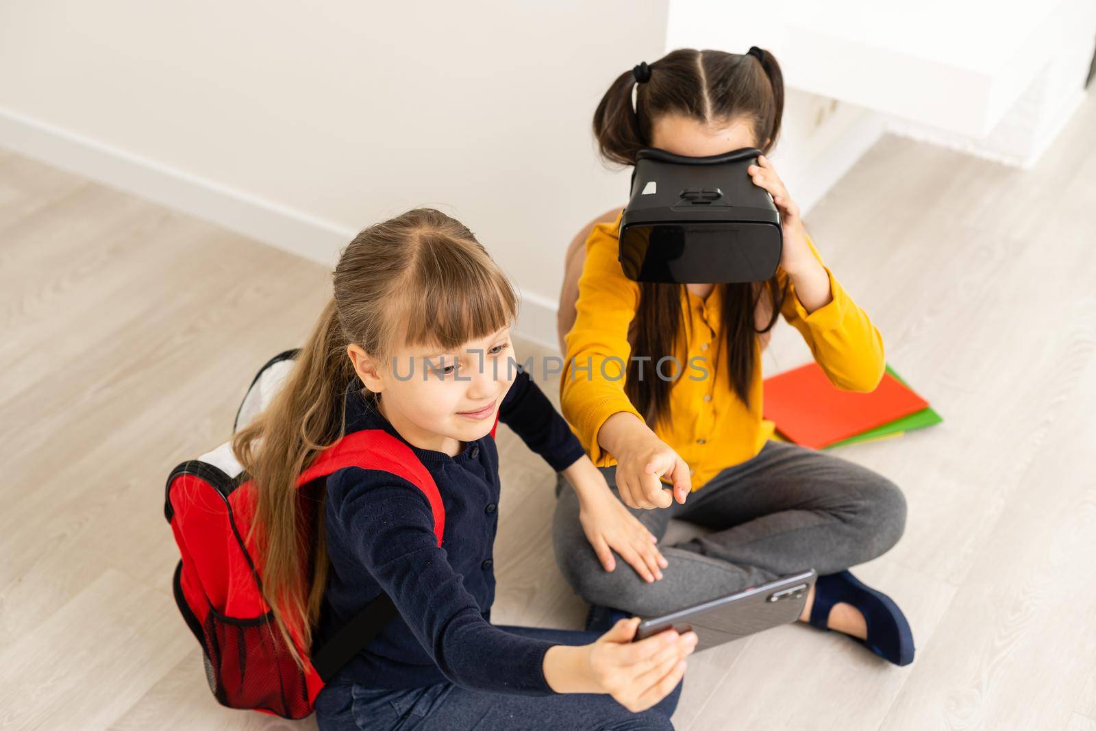 Studying in virtual reality. Modern technology. Interesting lesson. Virtual teaching. Homeschooling online. Girl kid study in virtual school. Virtual education. Child cute pupil wear hmd vr glasses