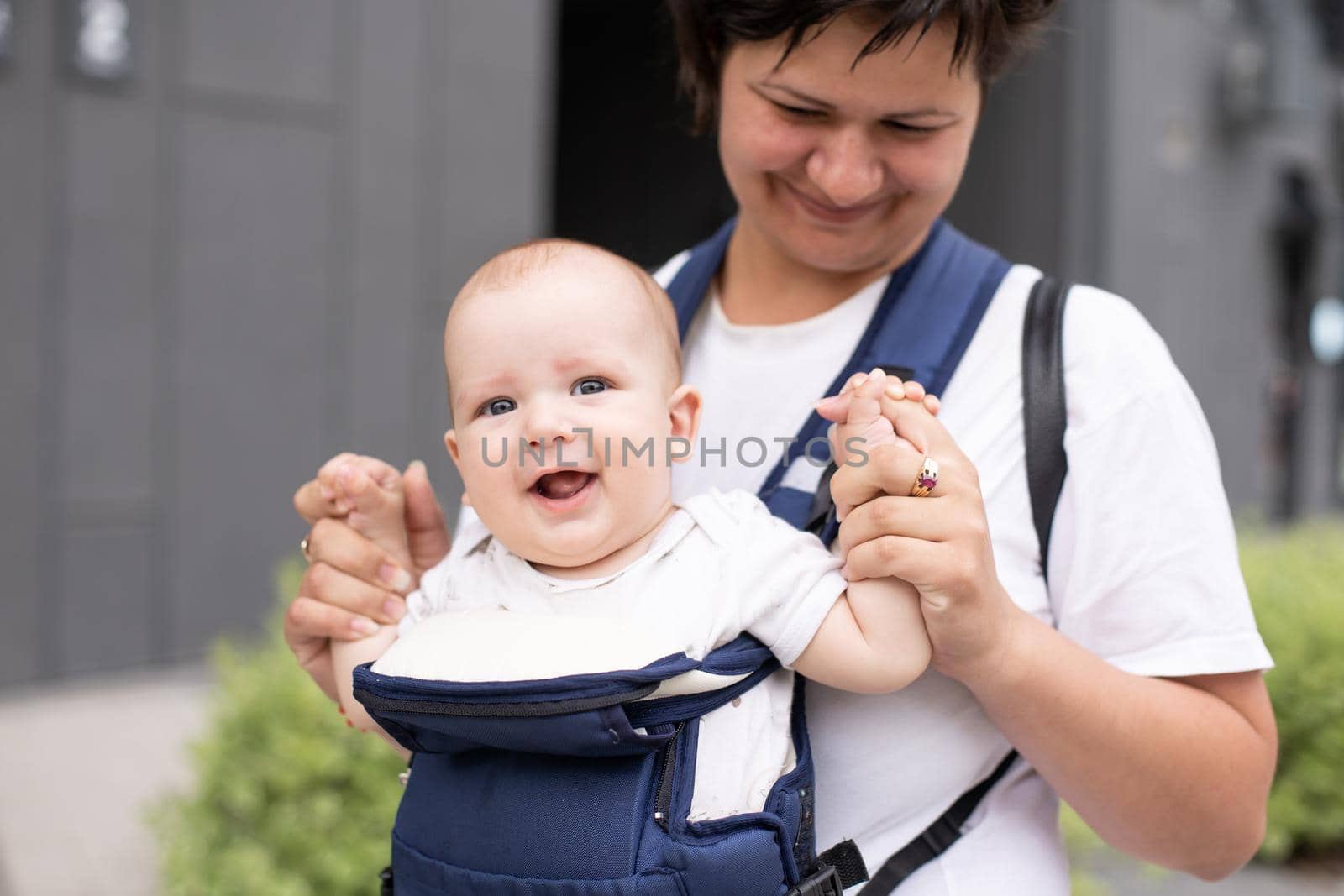 Portrait of beautiful happy smiling mother with baby outdoor.