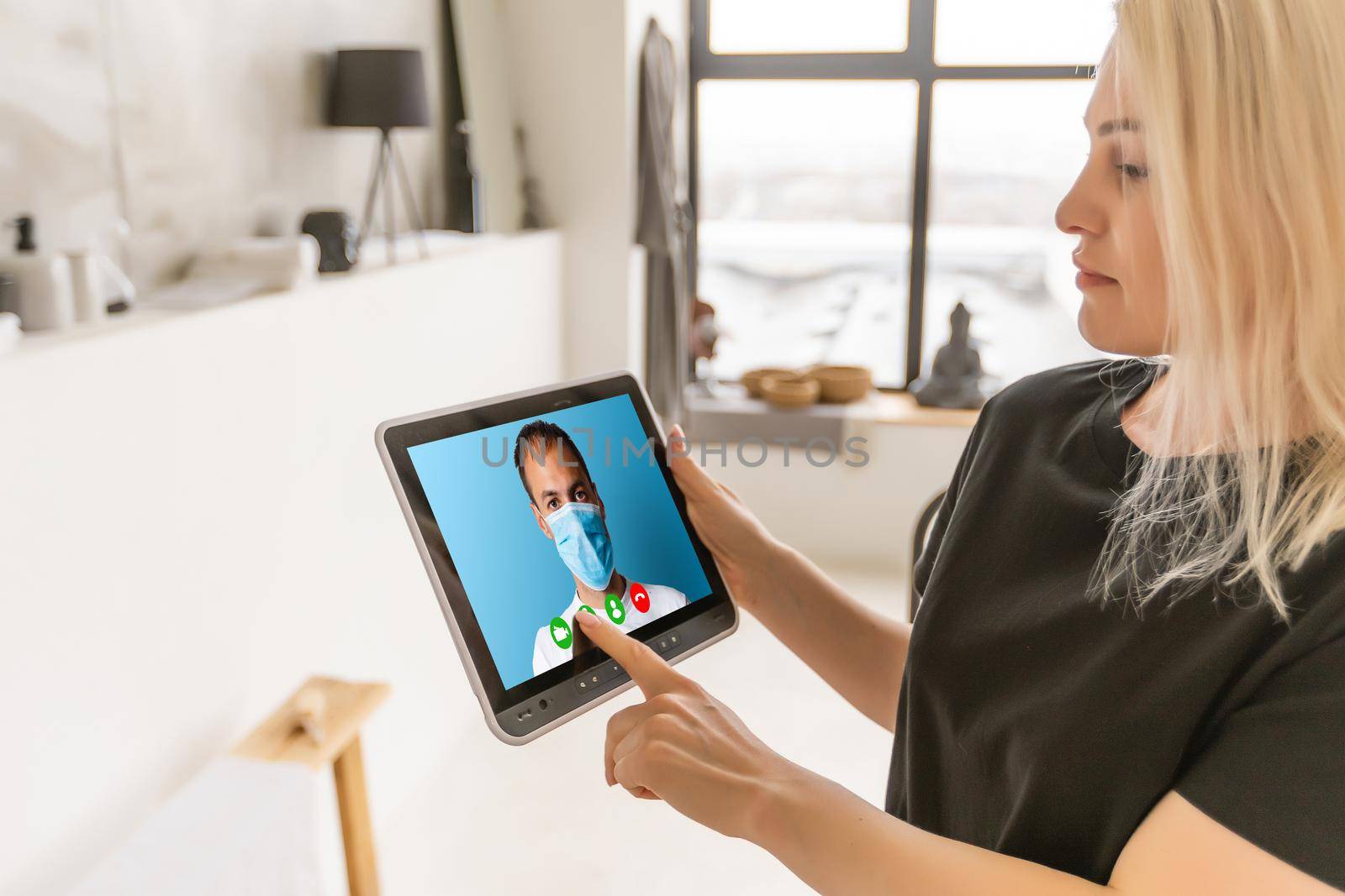 Woman talking with a doctor online using digital tablet, feeling bad at home. Concept of telemedicine and patient counseling online.