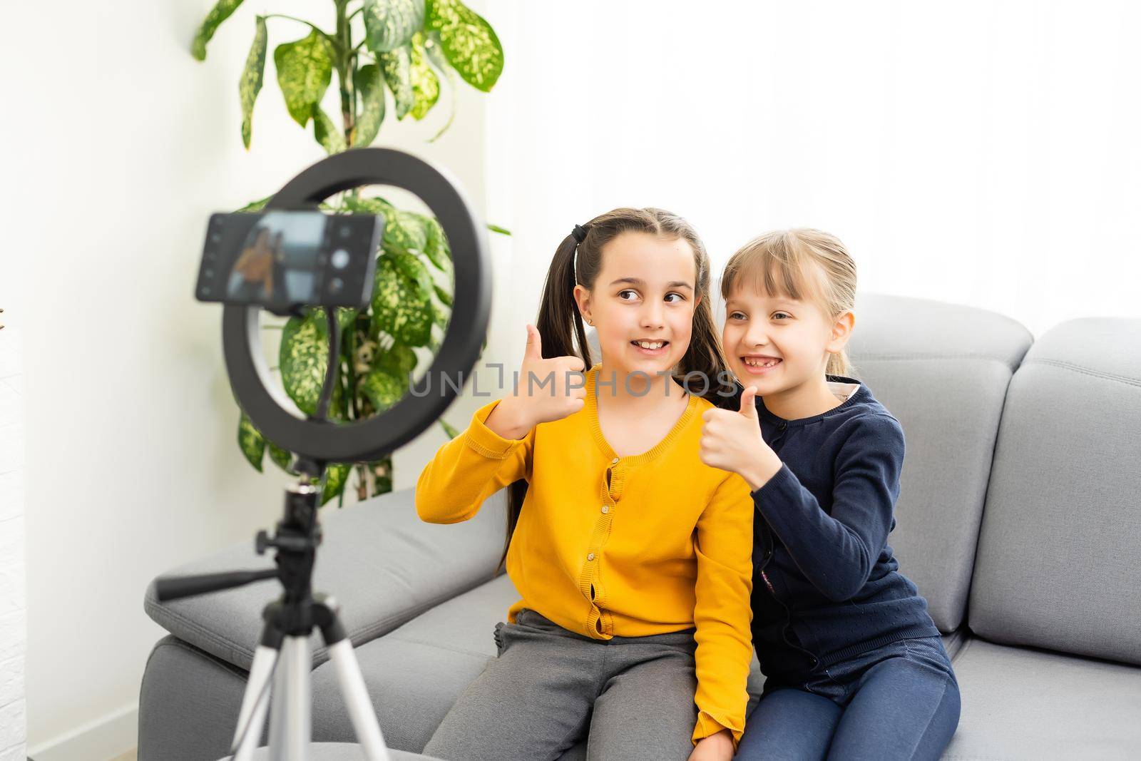 Close up photo two little girls take selfies, talk, tell, speak by Andelov13