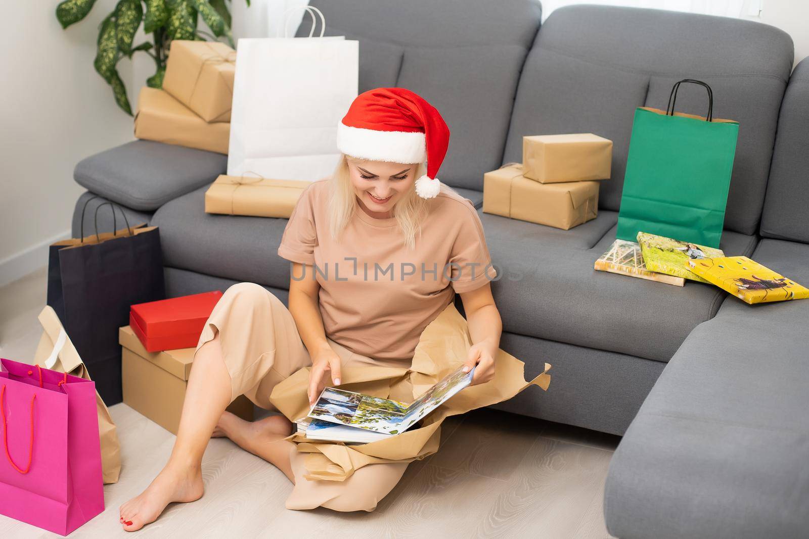 woman watching photobook and unpacking gifts