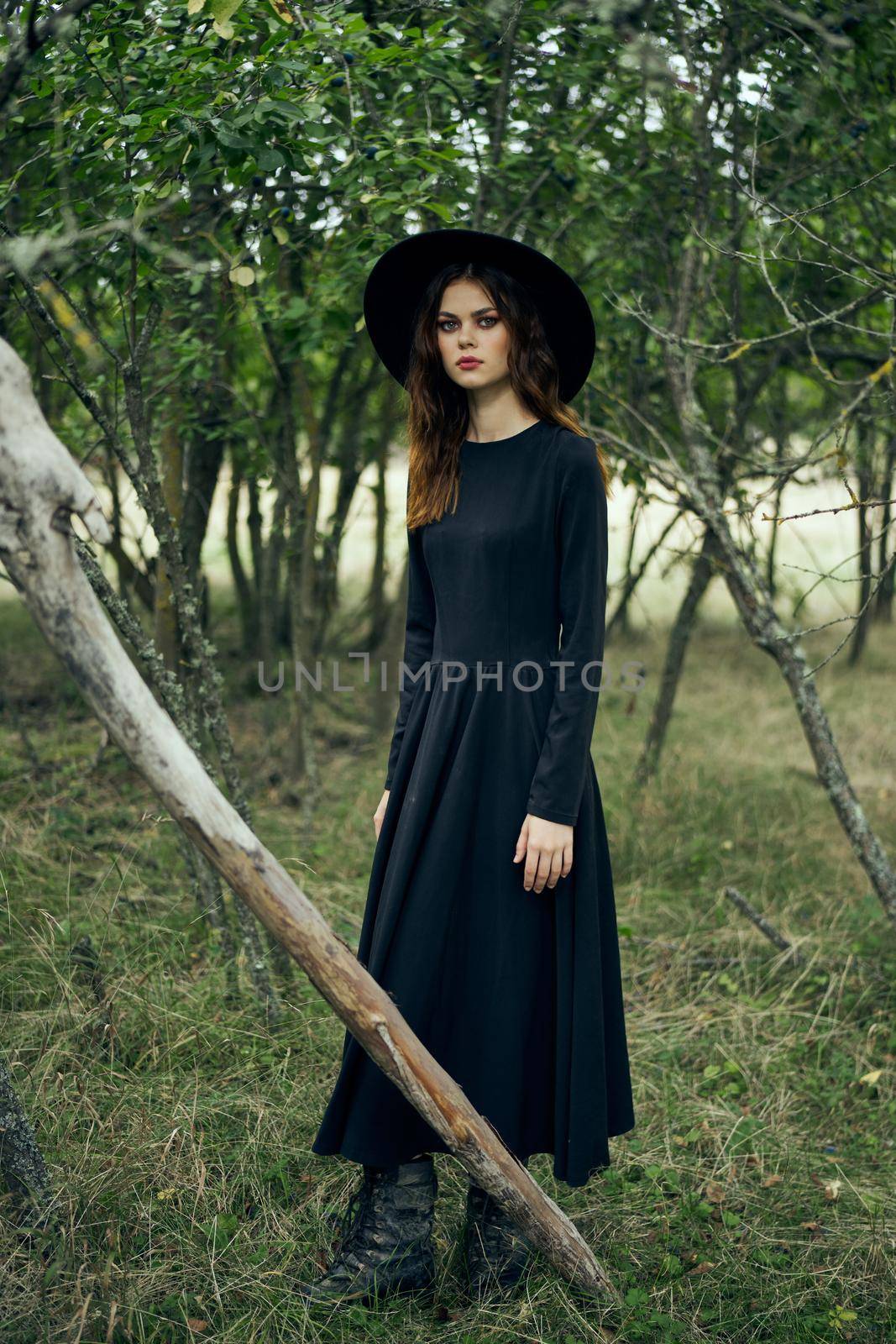 woman in black suit Witch in a fantasy forest by Vichizh