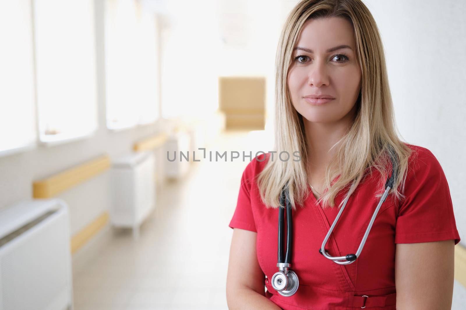 Beautiful woman doctor in the hospital corridor, close-up. Health center staff, ambulance, clinic reception