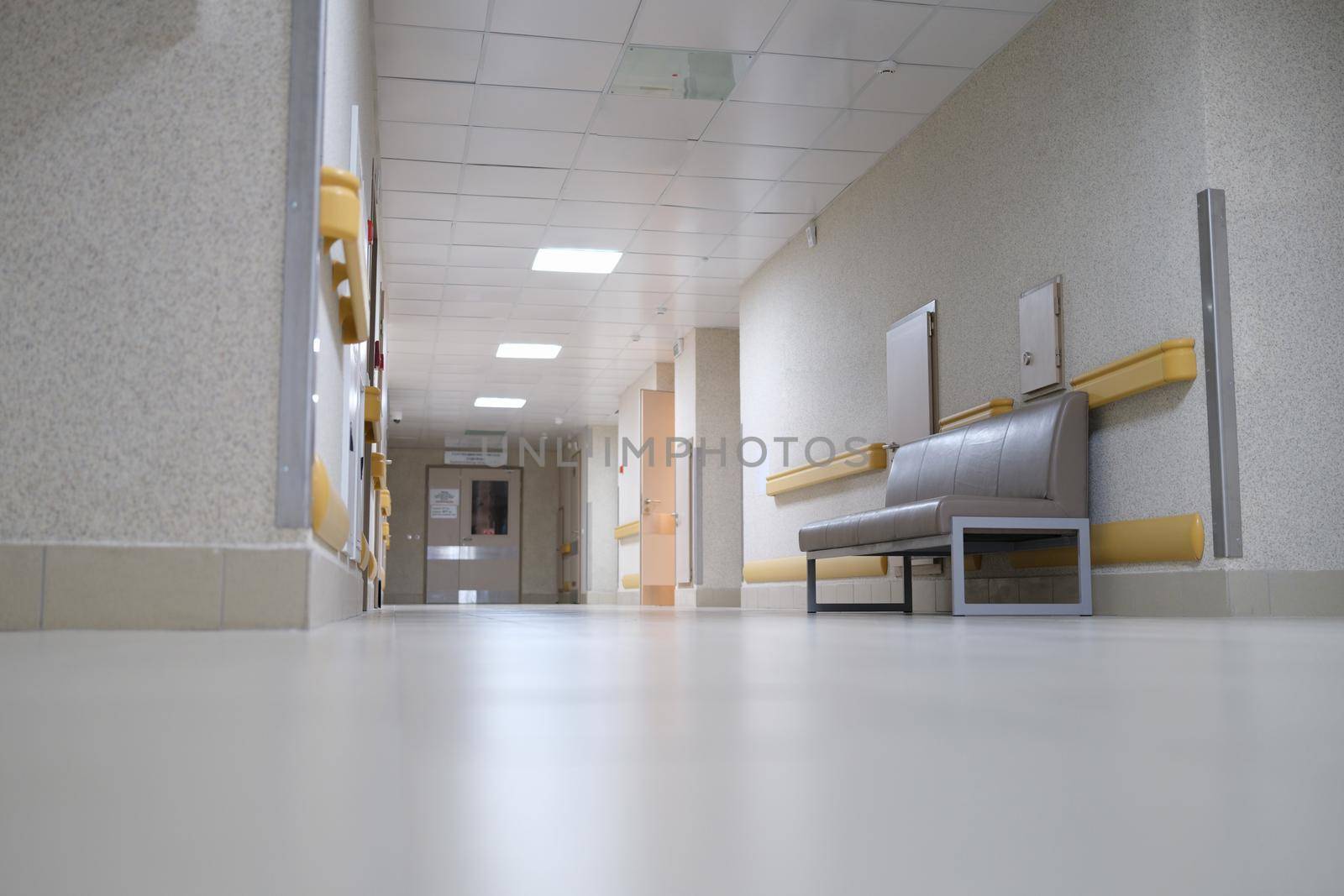 Empty long white hospital corridor, modern interior. Sterile resuscitation floor in the treatment center
