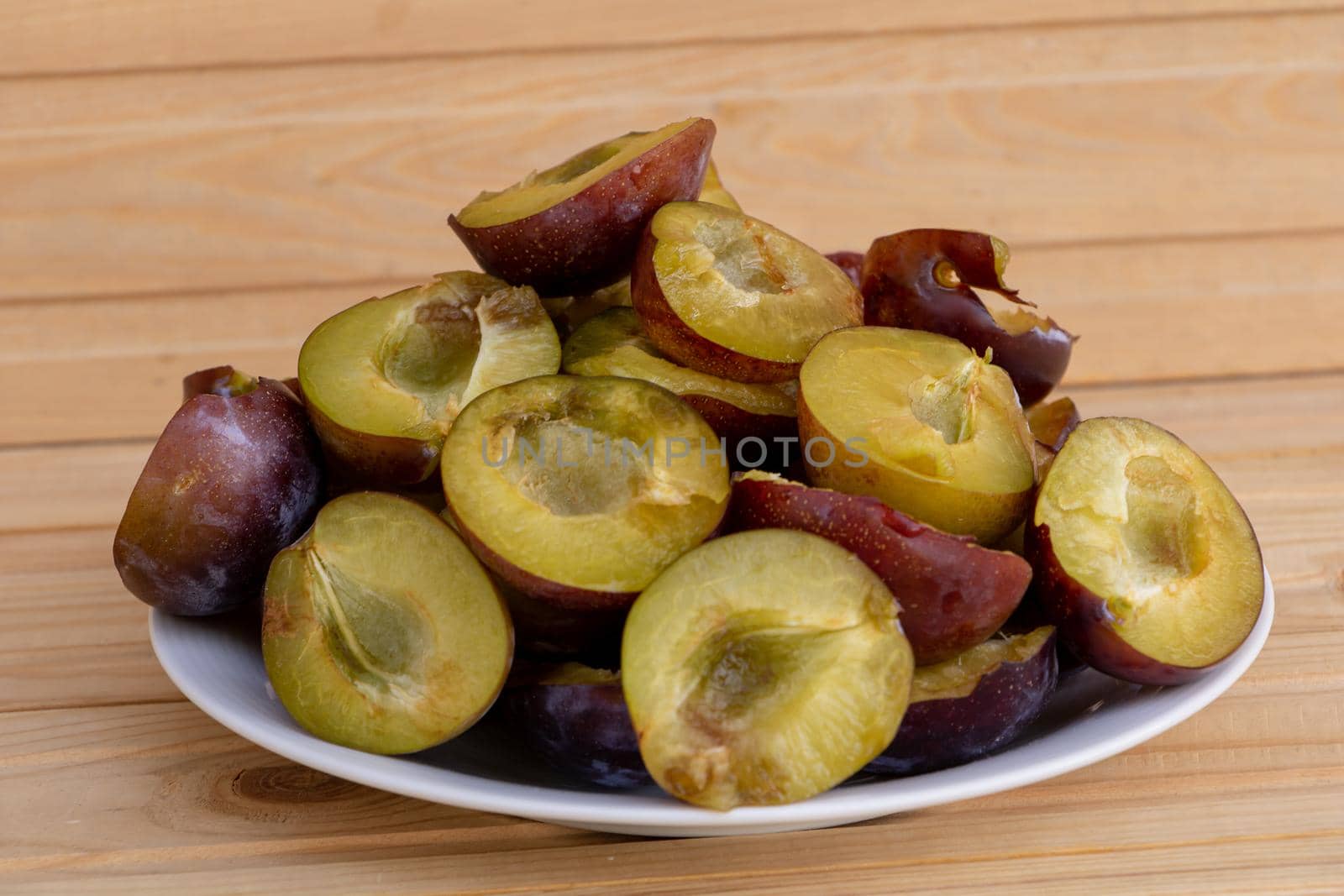 A plate full of tasty and juicy plums.