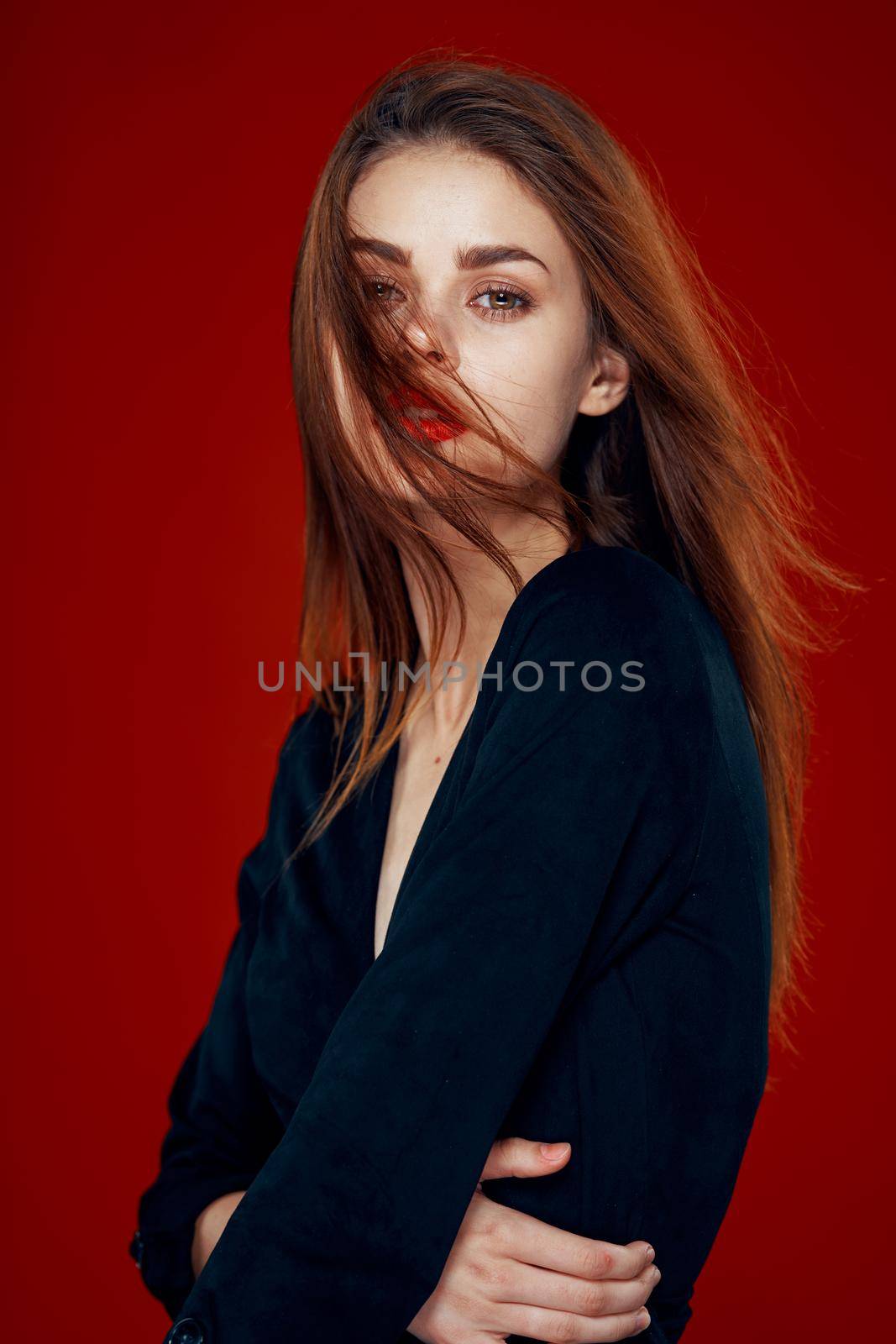 pretty woman with red lips red hair Glamor posing red background. High quality photo