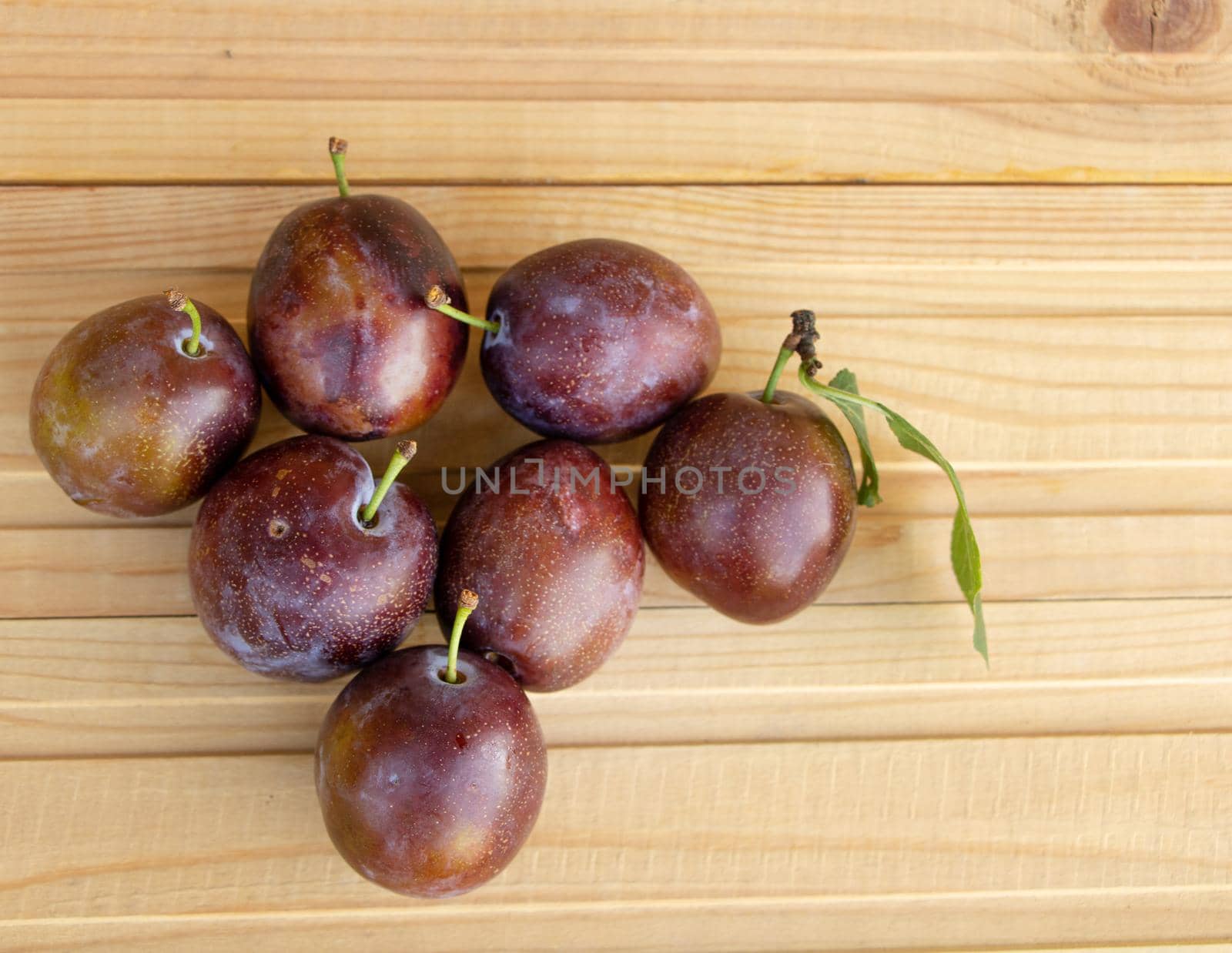 Fresh juice plums on a wooden background. plums benefits concept.