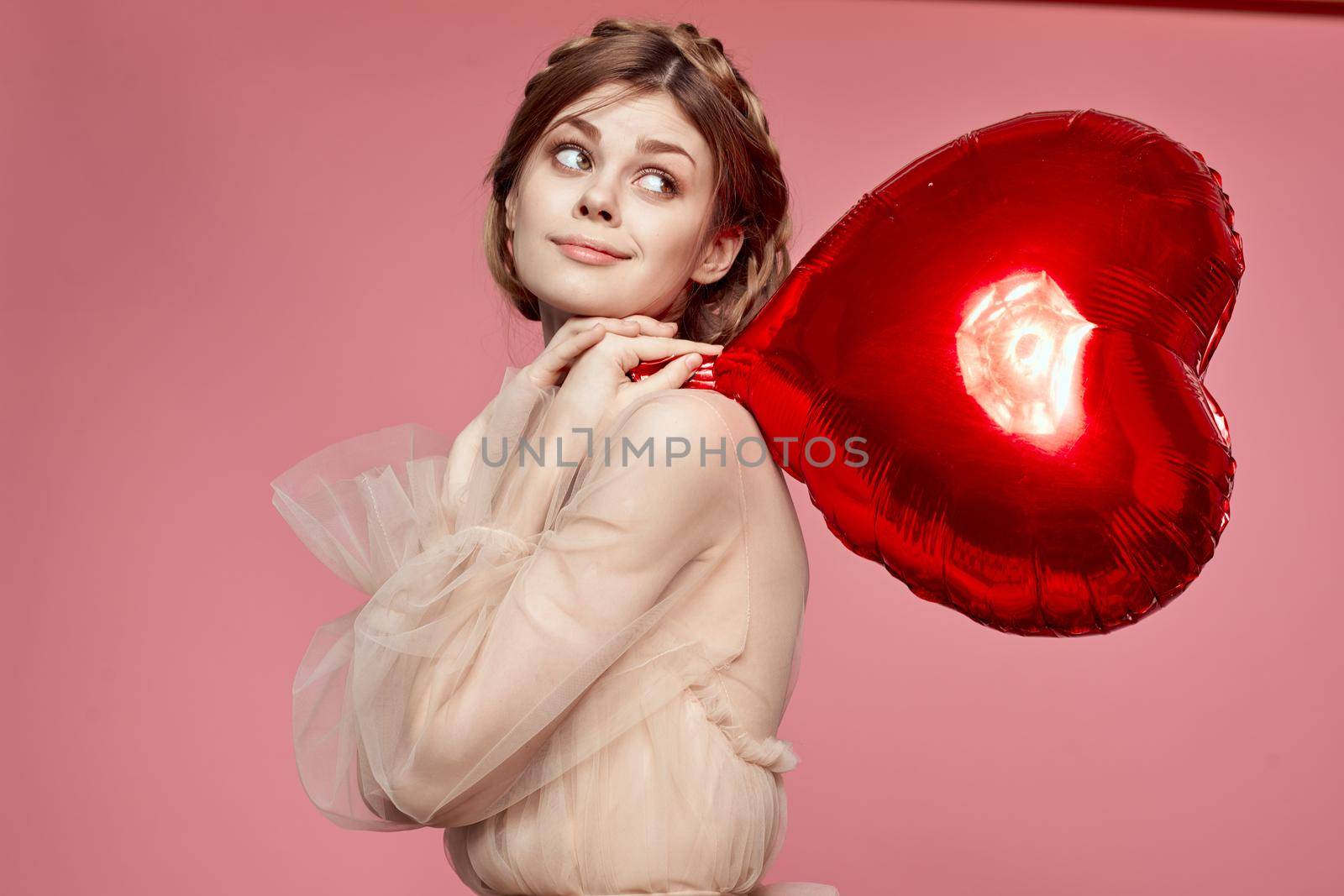 pretty woman in a dress balloon Valentine's Day pink background. High quality photo