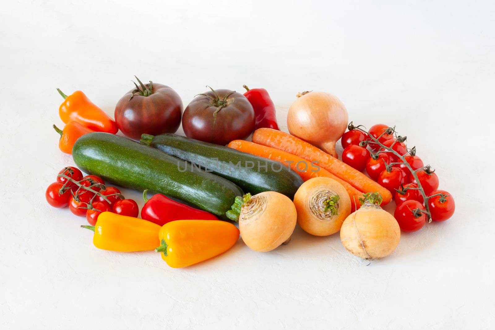 bright organic vegetables on the white background, concept of healthy food