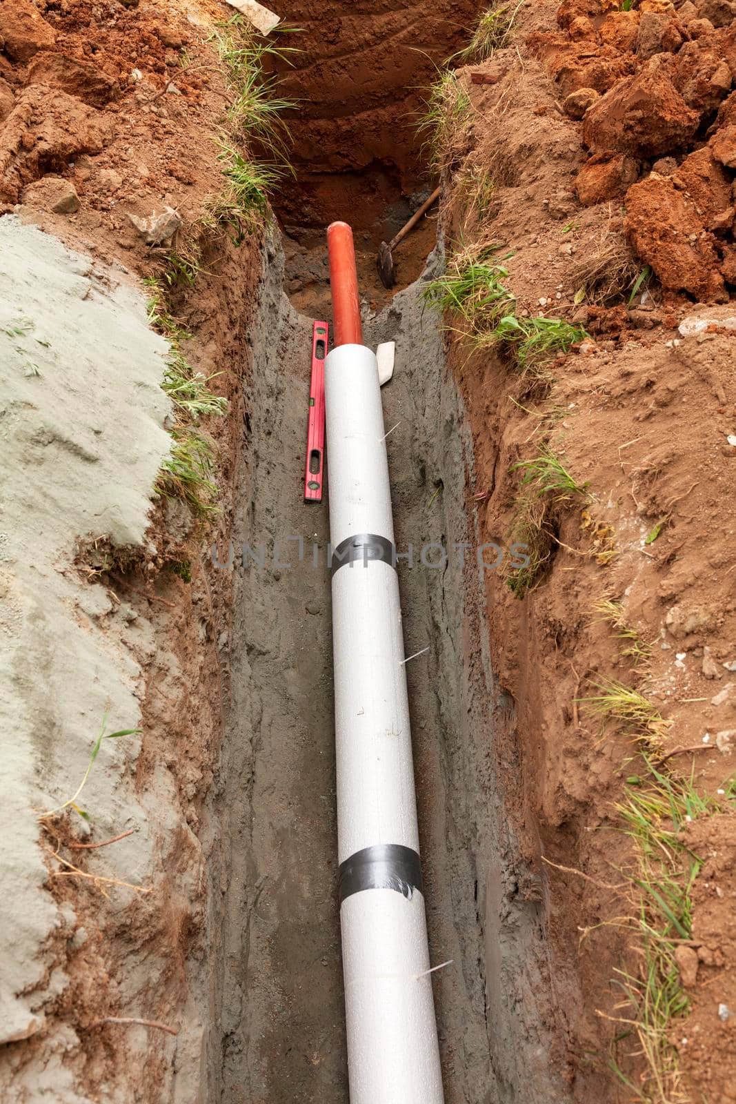 Installation of water main, sanitary sewer, storm drain systems, plastic pipes wrapped in insulation by Nobilior