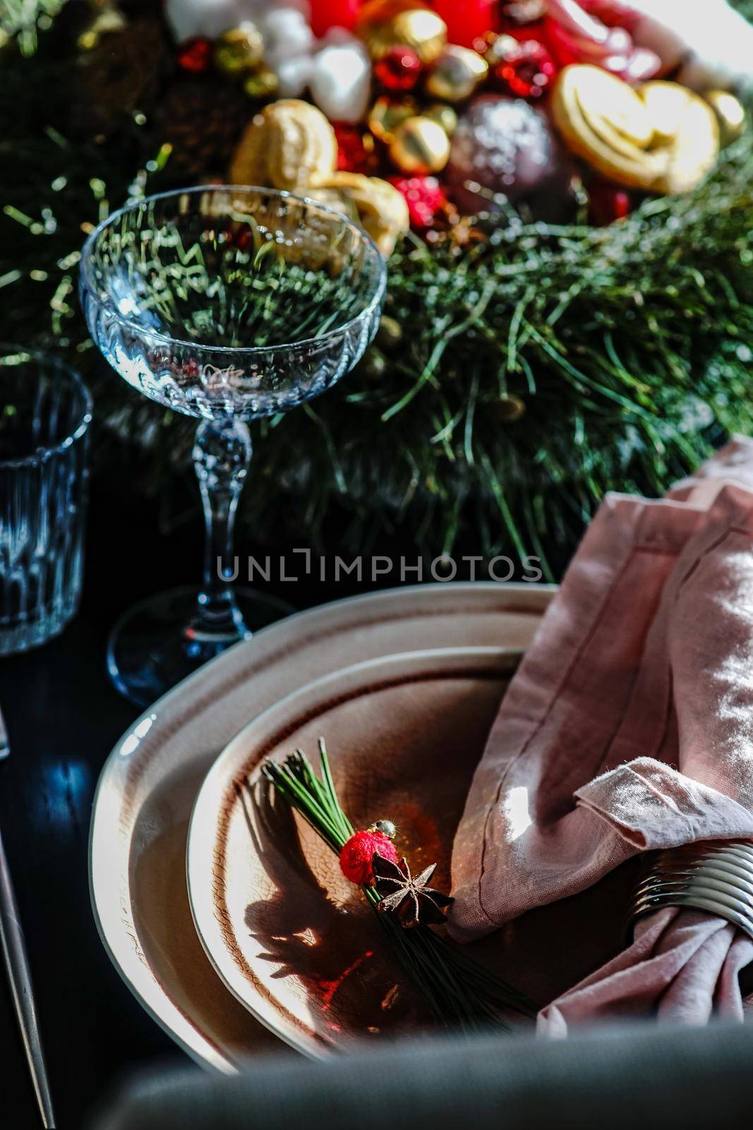 Table setting for festive Christmas dinner on black wooden table