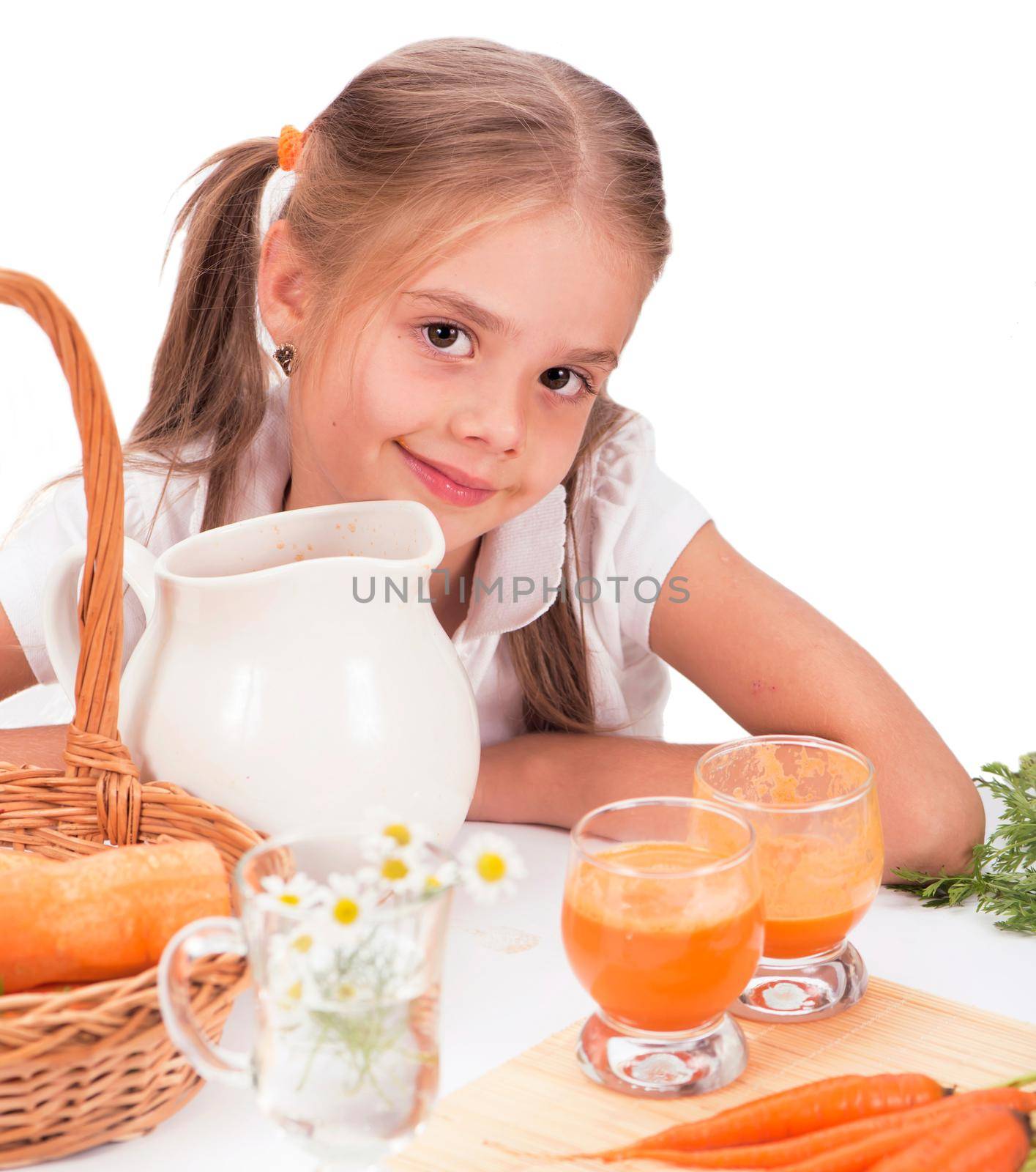 Cute little girl drink carrot juice. White background.