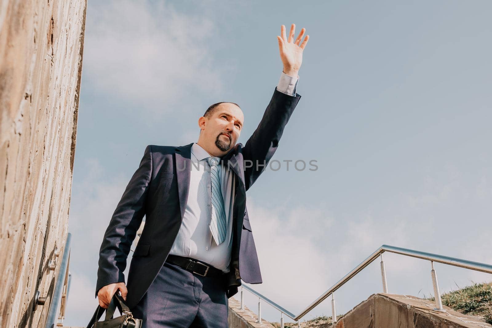Business executive with briefcase going down the stairs.