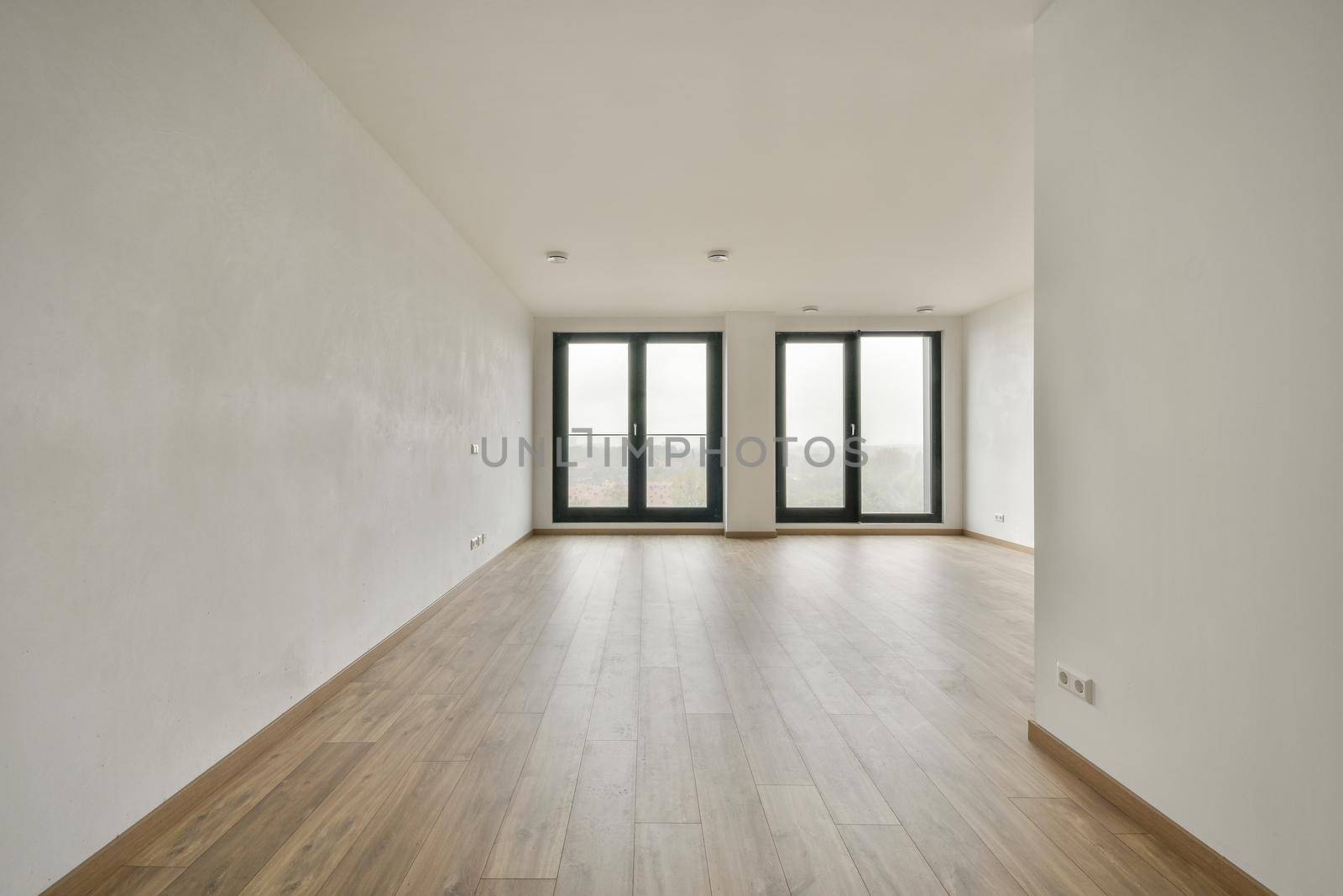 Modern room with wooden floor and white walls