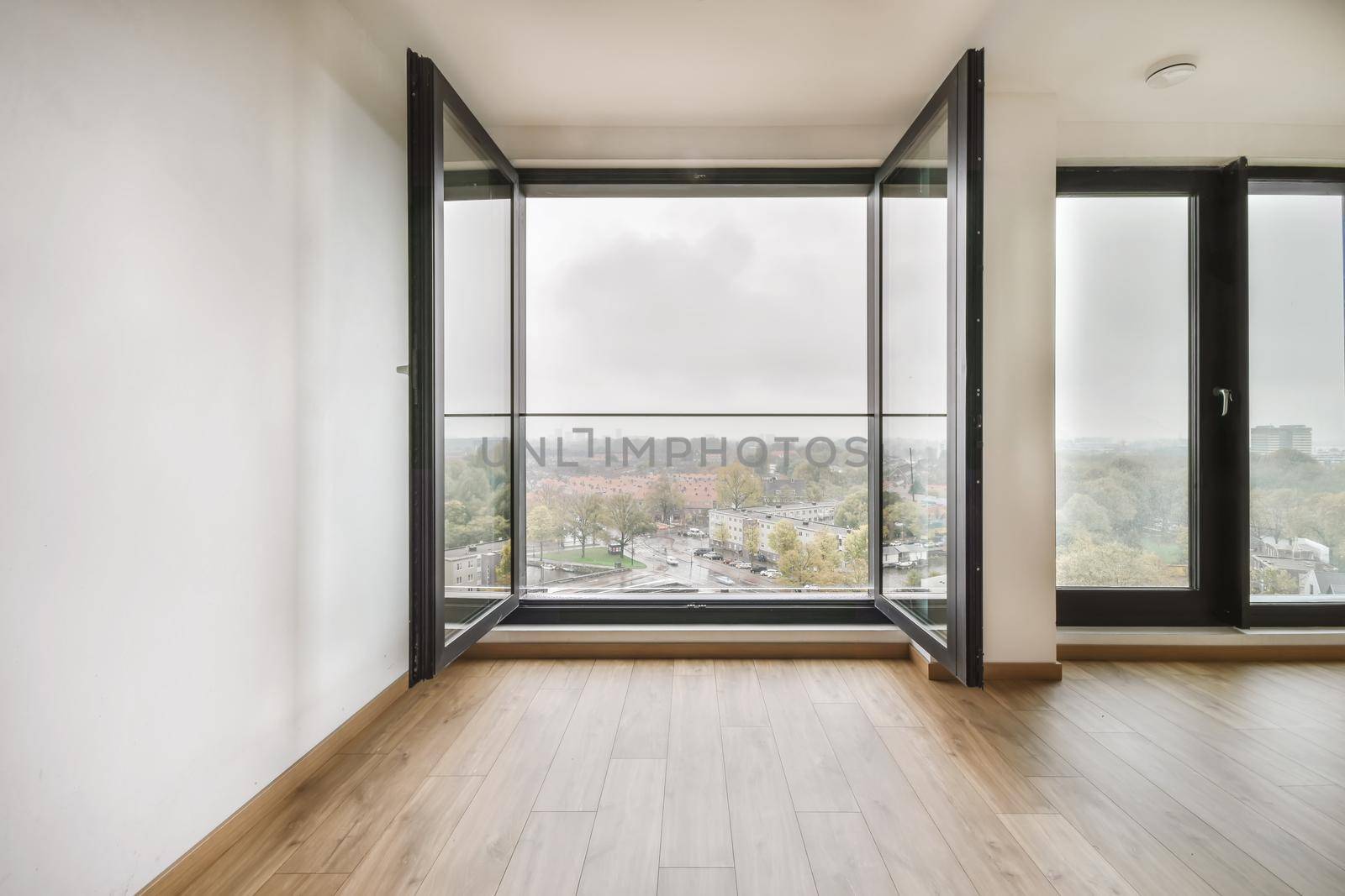 Modern room with wooden floor and white walls