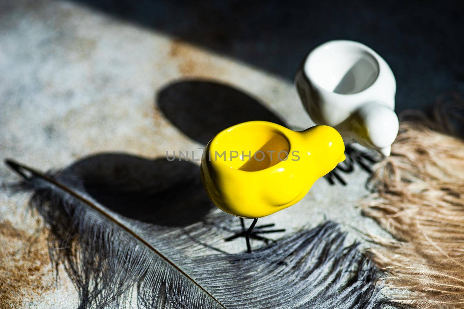 Easter holiday card concept with egg holden in shape of chichen with deep shadows