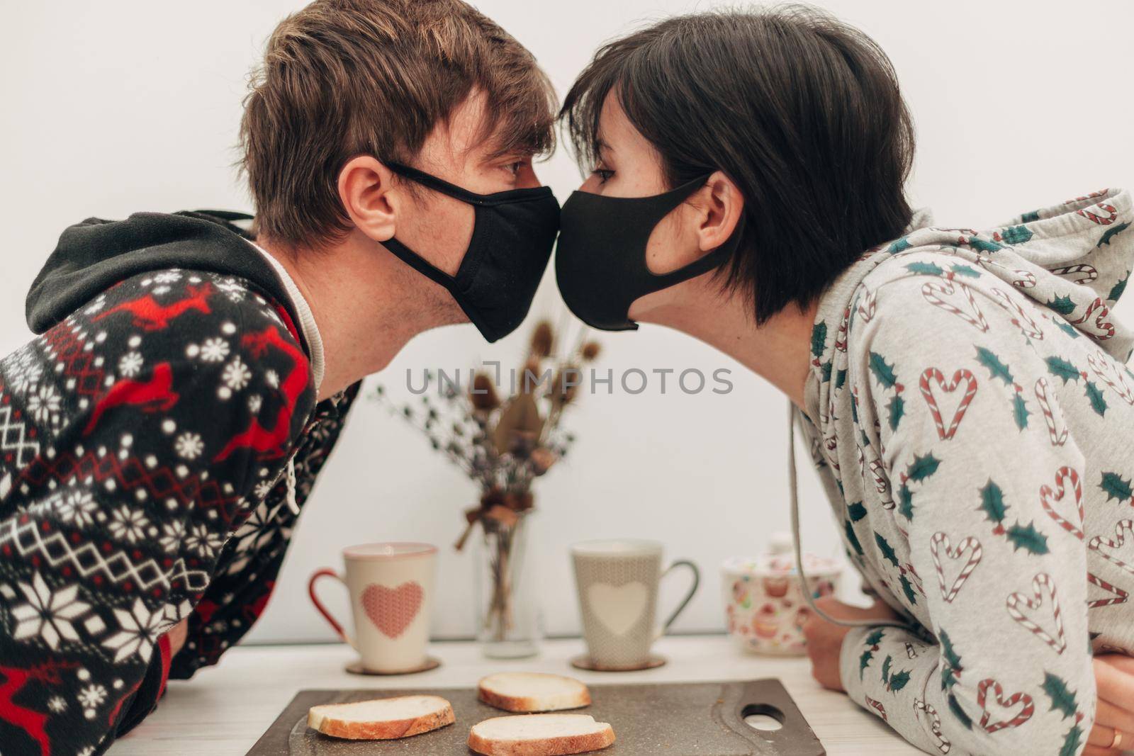 Girl and Boy Kissing in Masks on Coronavirus Quarantine by TrEKone