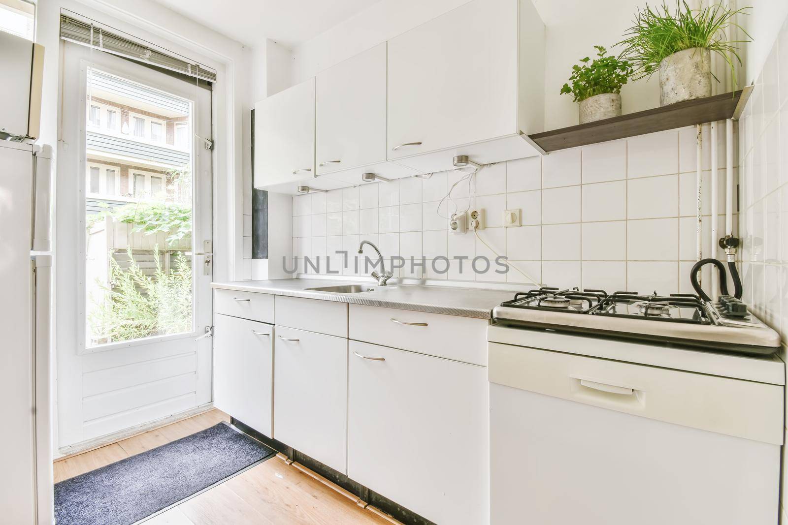 Large kitchen with white kitchen unit and parquet floor