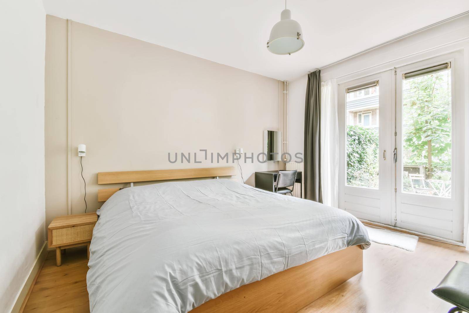 A bedroom in the light of day with a soft blue monochromatic synthphone cover