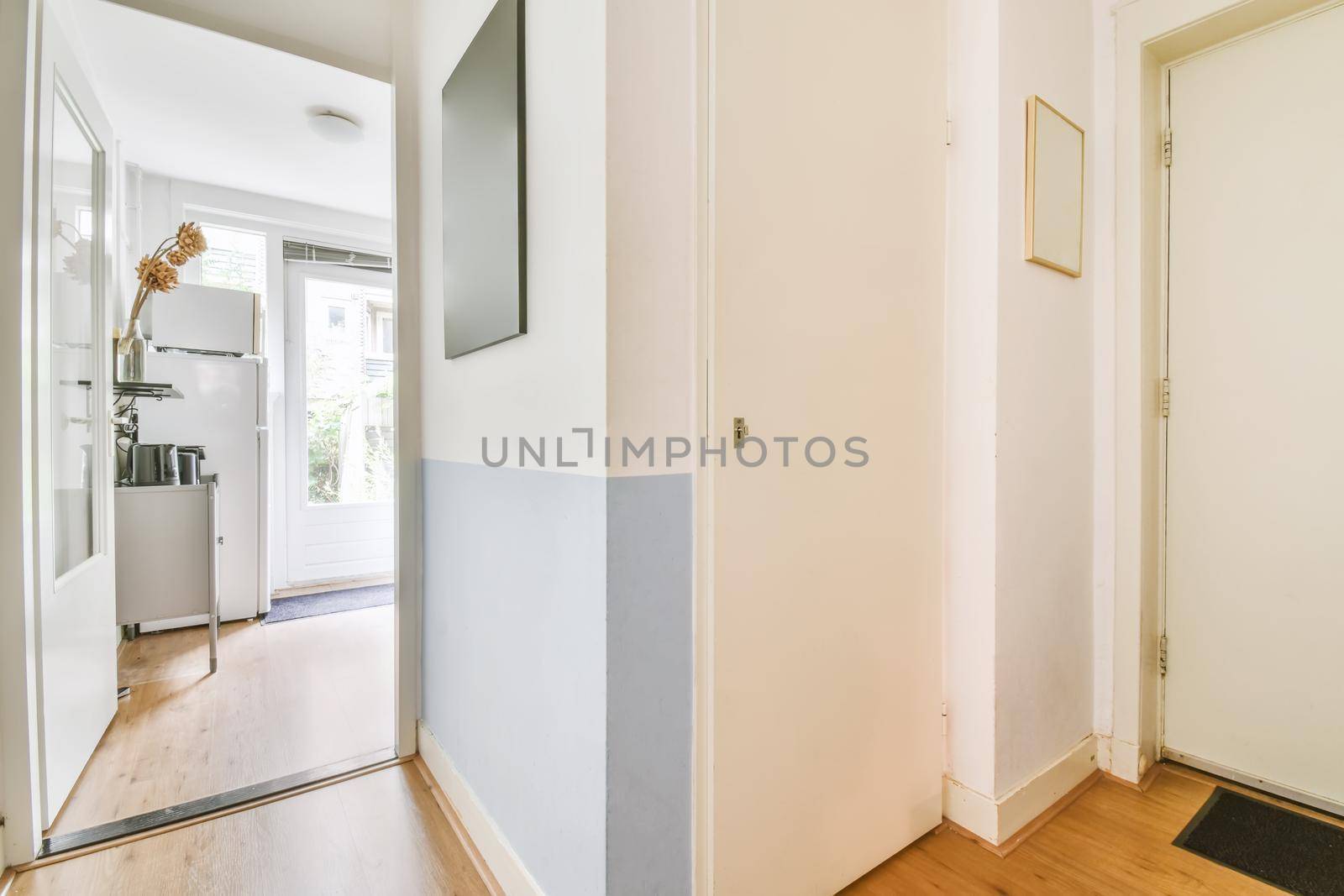 Delicate corner corridor with paintings hanging on the wall