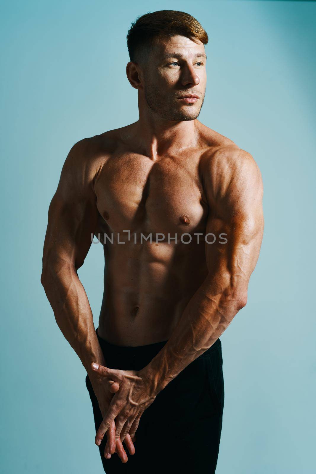 male with bulging topless muscle workout posing bodybuilder. High quality photo