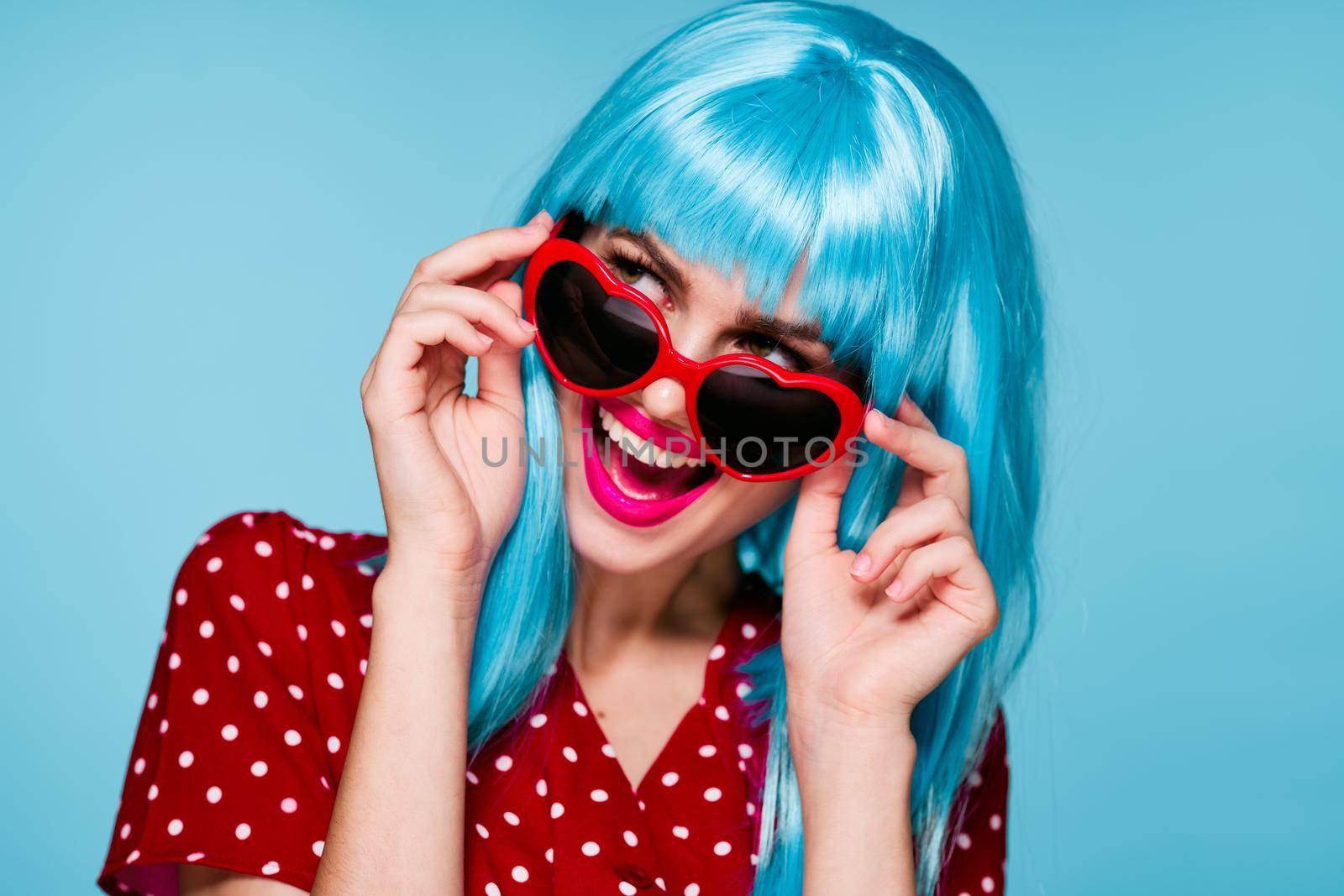 glamorous woman purple hair posing sunglasses blue background. High quality photo