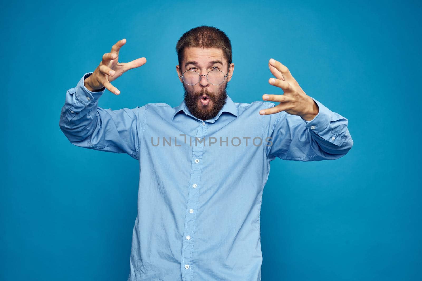 business man with glasses emotions blue background. High quality photo