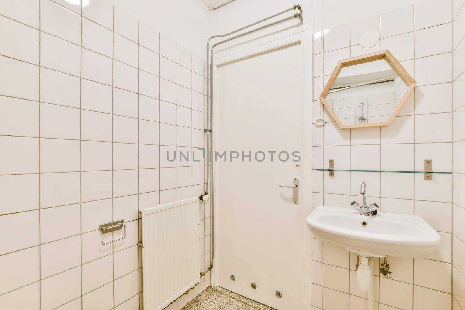 Bright bathroom with white tiles on all walls