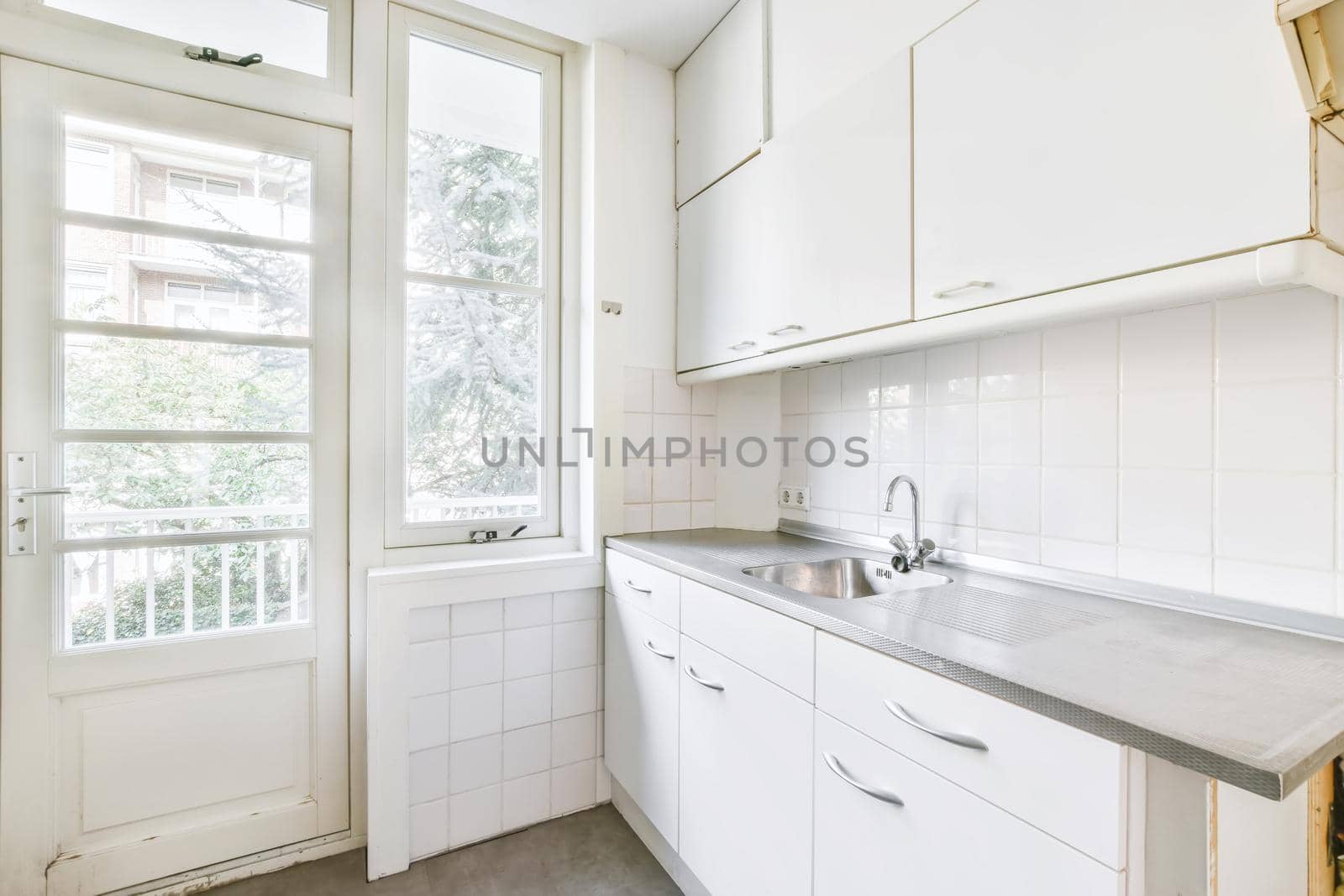 Miniature kitchen in white tones and a window on one side