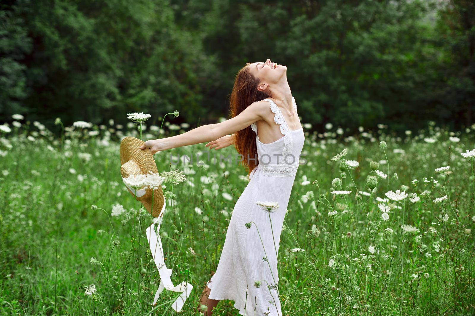 cheerful woman in a field outdoors flowers fresh air freedom by Vichizh