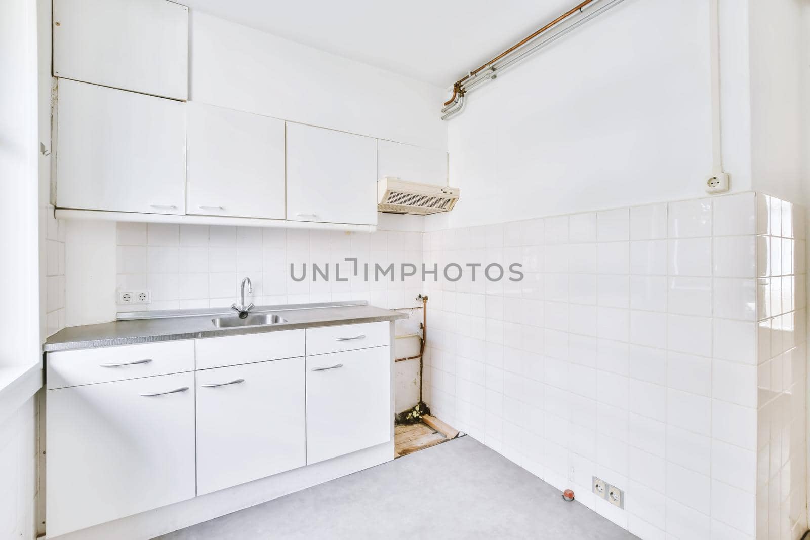 Miniature kitchen in white tones and a window on one side
