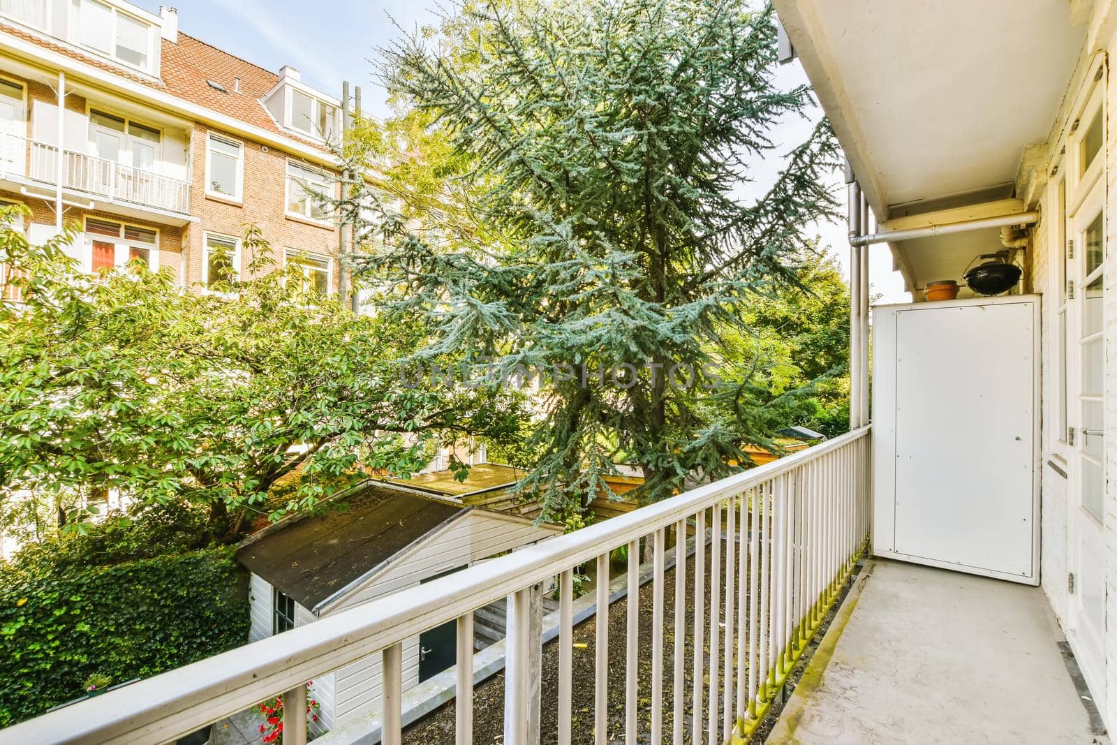 Attractive long narrow balcony with wooden handrails