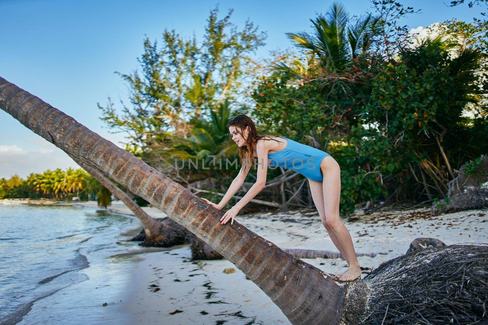 woman wearing sunglasses blue swimsuit island beach sun by Vichizh