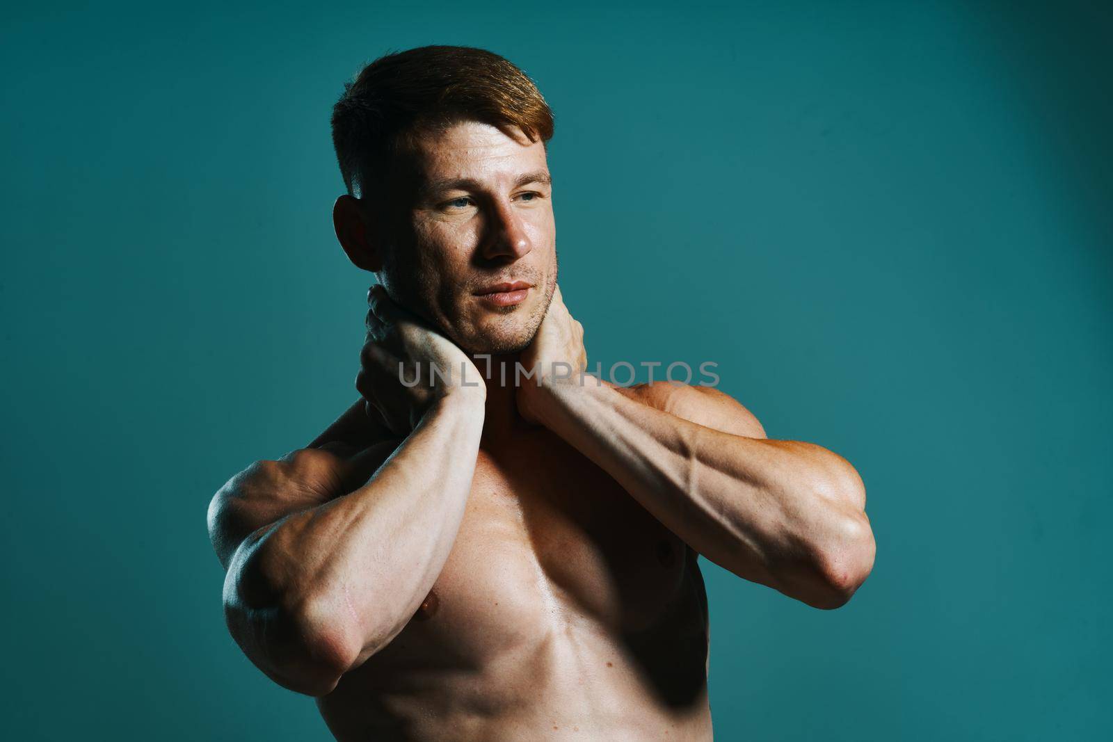 athletic man with pumped up muscular body workout green background by Vichizh