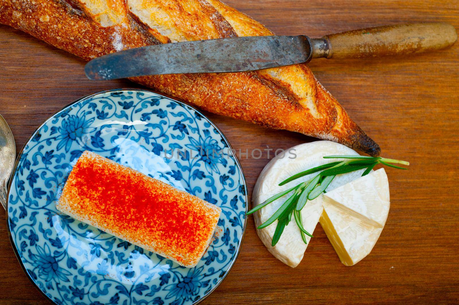 French cheese and fresh  baguette on a wood cutter